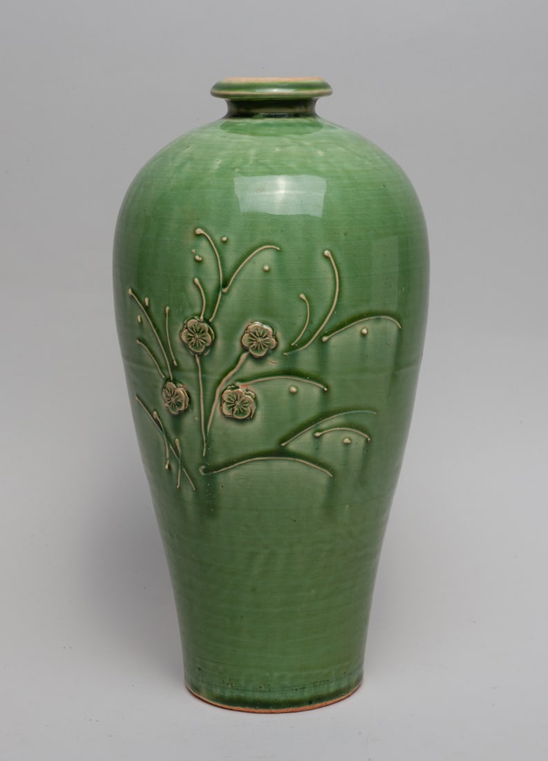 Korean Turquoise Glazed Porcelain Vase: Of baluster form, the exterior carved with flowers and glazed in grass-green color. Approx. 12.2-6 inch.