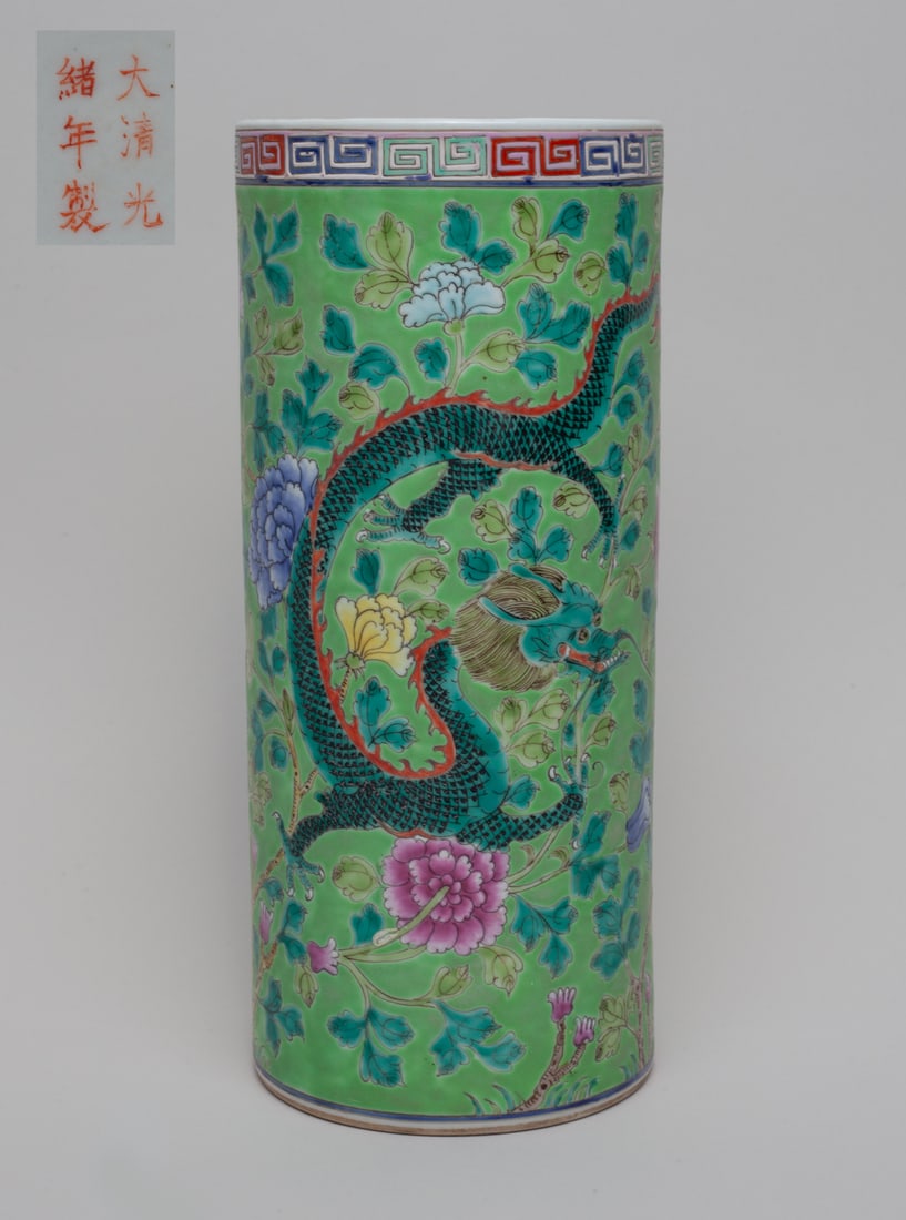 Chinese Famille Rose Porcelain Vase: Of tall cylindrical form, the exterior enameled with dragons among flower stems on apple green ground, the bottom marked with six characters. Approx. 10.7-4.6 inch.