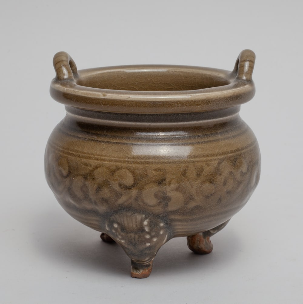 Chinese Yaochou Porcelain Censer: The compressed globular body supported on three cabriole beast legs, carved in low relief with foliage scrolls, covered overall on crackled olive-green glaze. Approx. 4.3-4.3 inch.