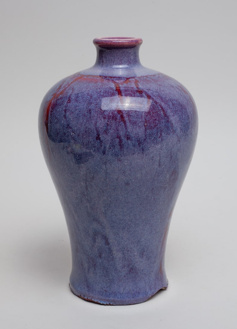 Chinese Flambe Glazed Porcelain Vase: Of baluster form, the exterior covered in lustrous streaked purple-red glaze. Approx. 8.8-5.3 inch.