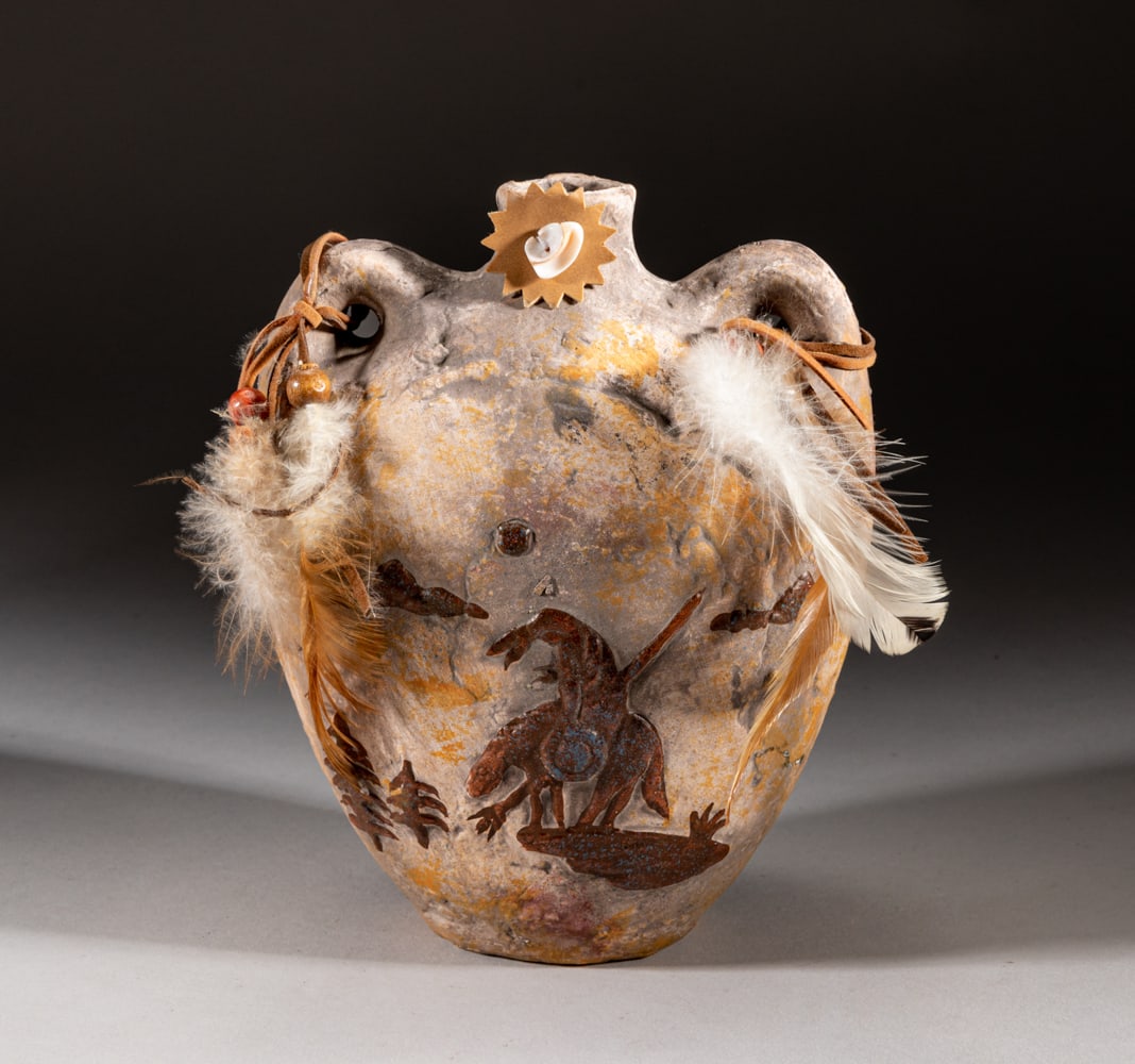 Collectible Zuni Clay Vase: Carved and painted with a figure holding spear and riding on beast, the upright handles decorated with beads and feather. Approx. 7.5-6.5-4 inch.