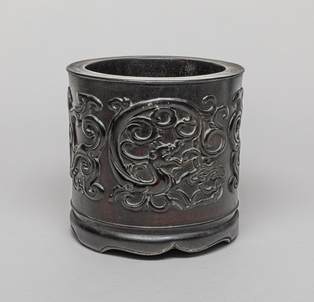 Large Chinese Carved Wood Brush Pot: Of cylindrical form, the exterior carved in high relief with sinuous archaistic dragons. Approx. 7.4-7.1 inch.