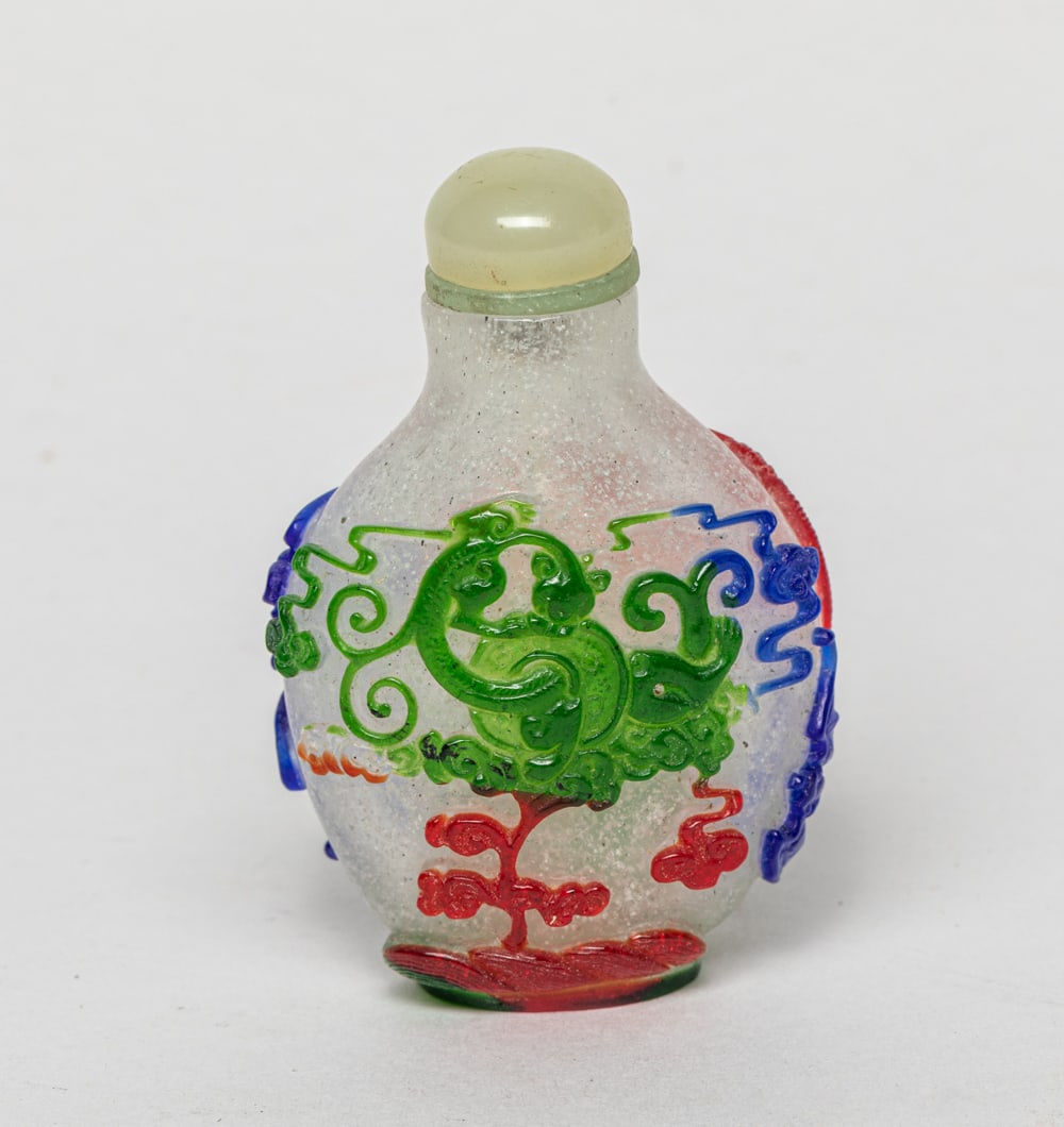 Rare Chinese Overlay Glass Snuff Bottle: One collectible Chinese glass snuff bottle carved with colored clouds, building, flying birds, bats and other elements, with a stopper. 1.8-1.1-2.8 inches.