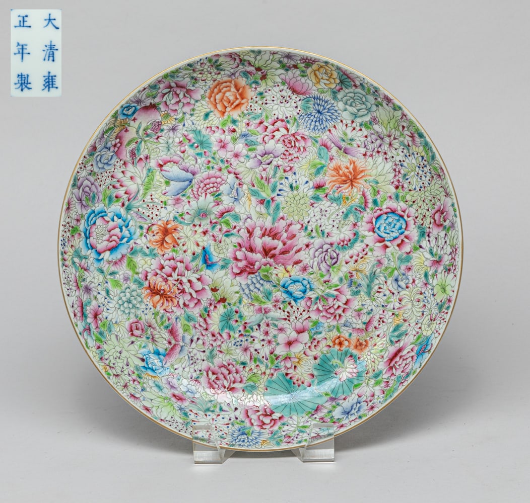 Chinese Famille Rose Porcelain Charger: One collectible glazed Chinese porcelain charger, interior overall painted with colored roses, lotus, peaches and other kinds, exterior painted with four brown-colored bats, a six-character mark at th