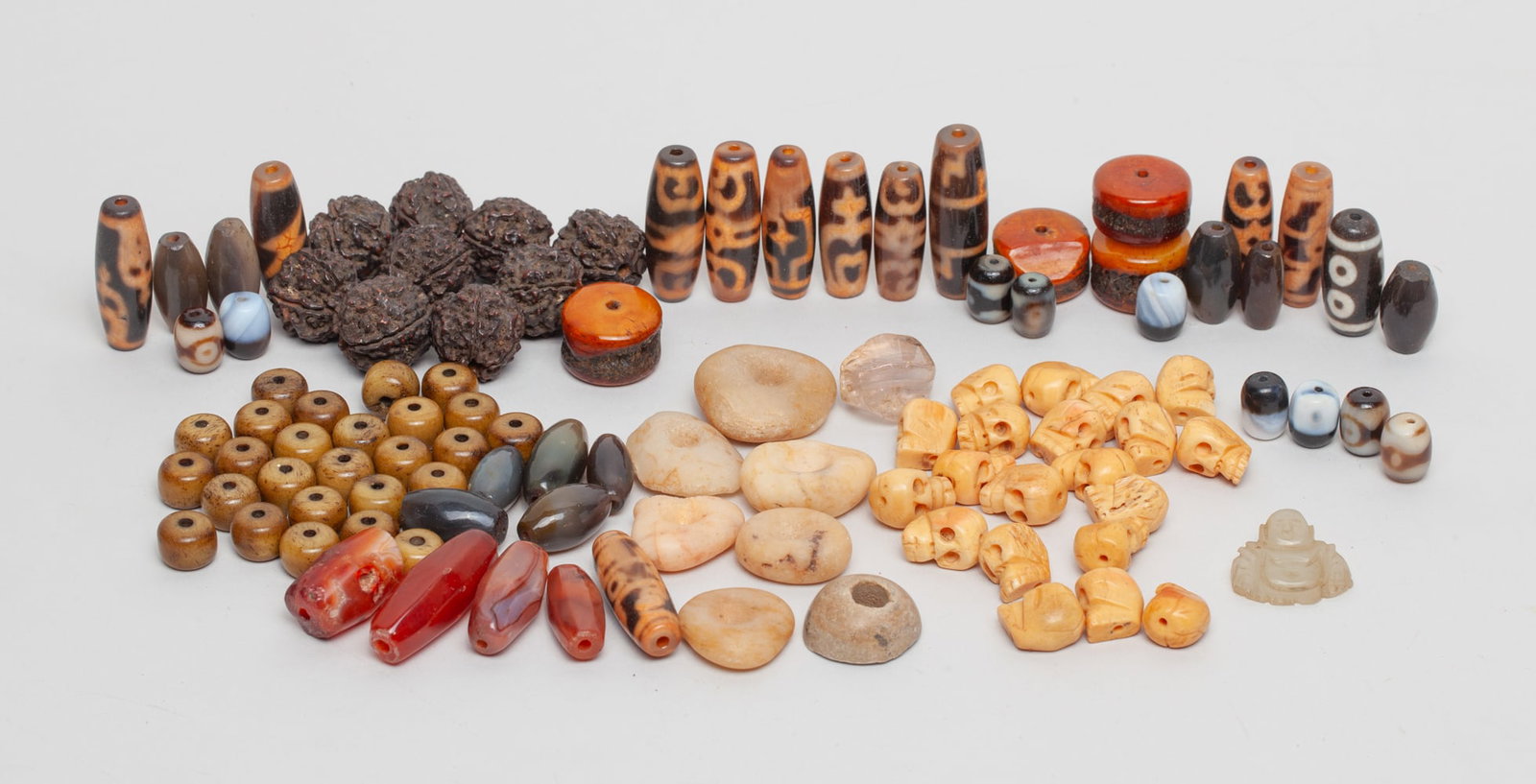 Lg Set Chinese/ Tibetan Beads Collection: A group of collectible Chinese/Tibetan beads, all carved in different shapes. Sizes vary.