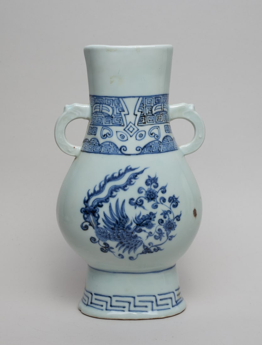 Chinese Export Porcelain Vase: With two dragon head handles, the vase painted with phoenix and flowers on both side, a band of Leiwei at the neck, the short base painted with Leiwen close to the bottom. Approx. 10.3-5.7-3.7 inches.