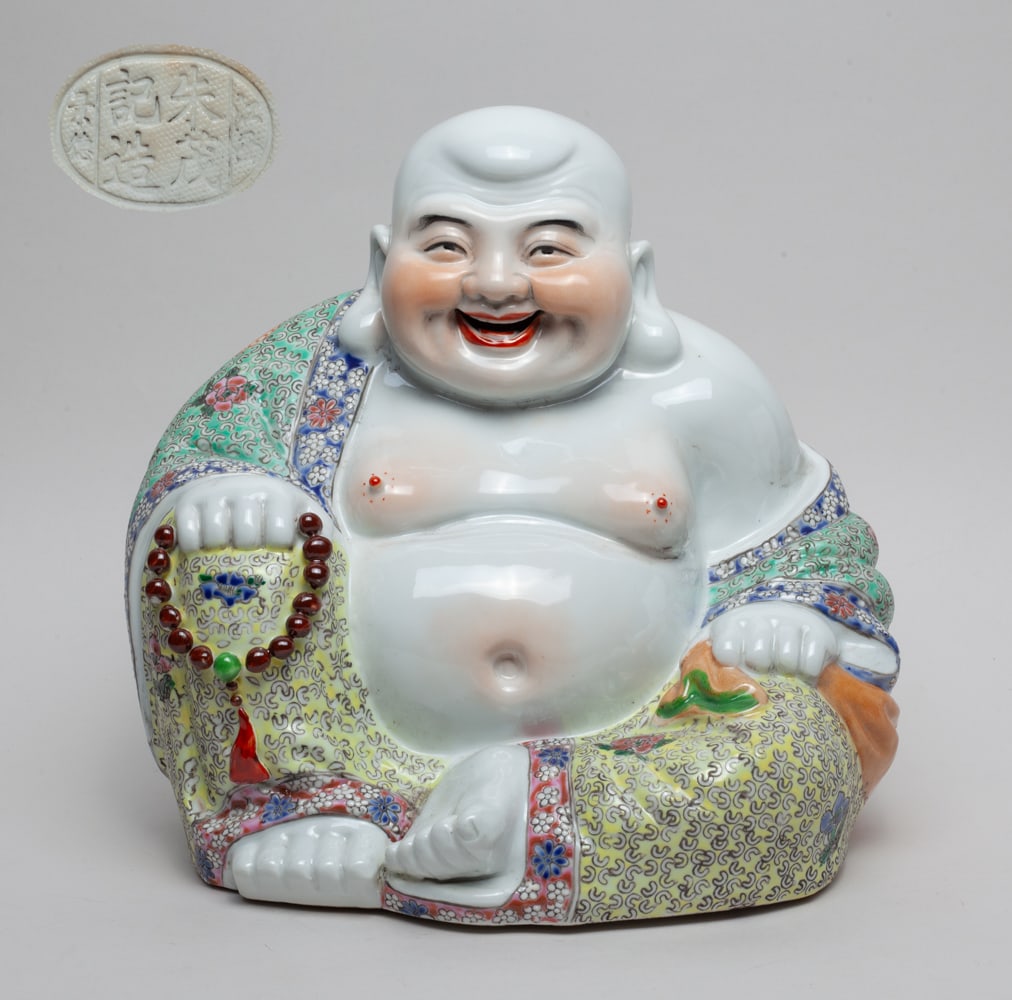 Chinese Lg Famille Rose Porcelain Buddha: Chinese large famille rose porcelain Buddha wearing a flower and Shou symbols decorated cassock, a ring of beads in right hand and a bag in left hand, bottom with a seal and a circular hole in center.