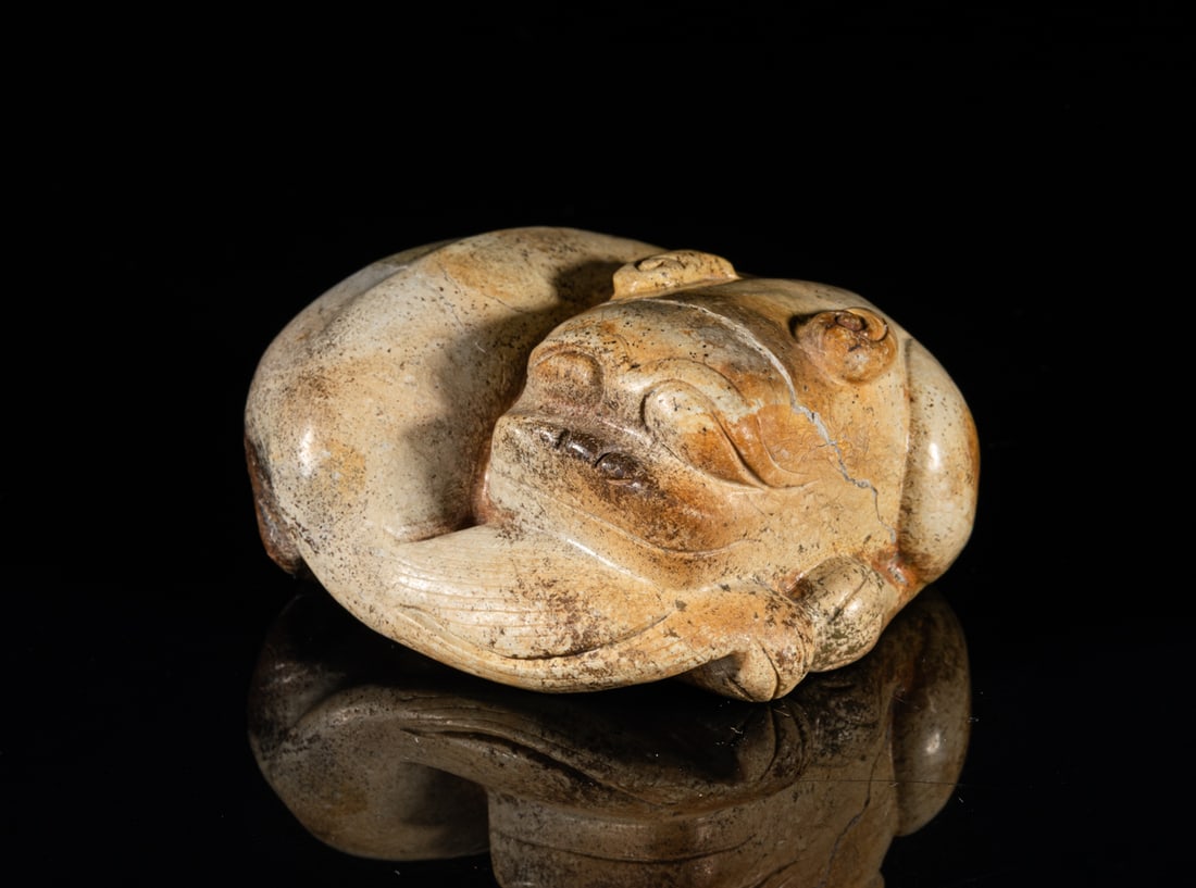Lg Chinese Ming Type Chicken Bone Jade: One collectible large Chinese Ming-type chicken bone jade, carved in the form of a crouching beast twisted in a looking-back stance, with its tail brushing its head. Approx. 3.1-2.9-1.5 inches.