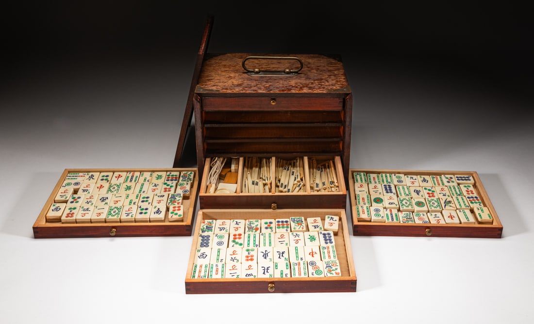 Chinese Wood Box & Bone Mahjong: One collectible Chinese Mahjong set, and one bone-made type game, the box with four drawers inside, with a foldable handle on the top. Approx. 9.7-7.1-6.7 inches (Box).The Estate of the Mitch.J. Mitch