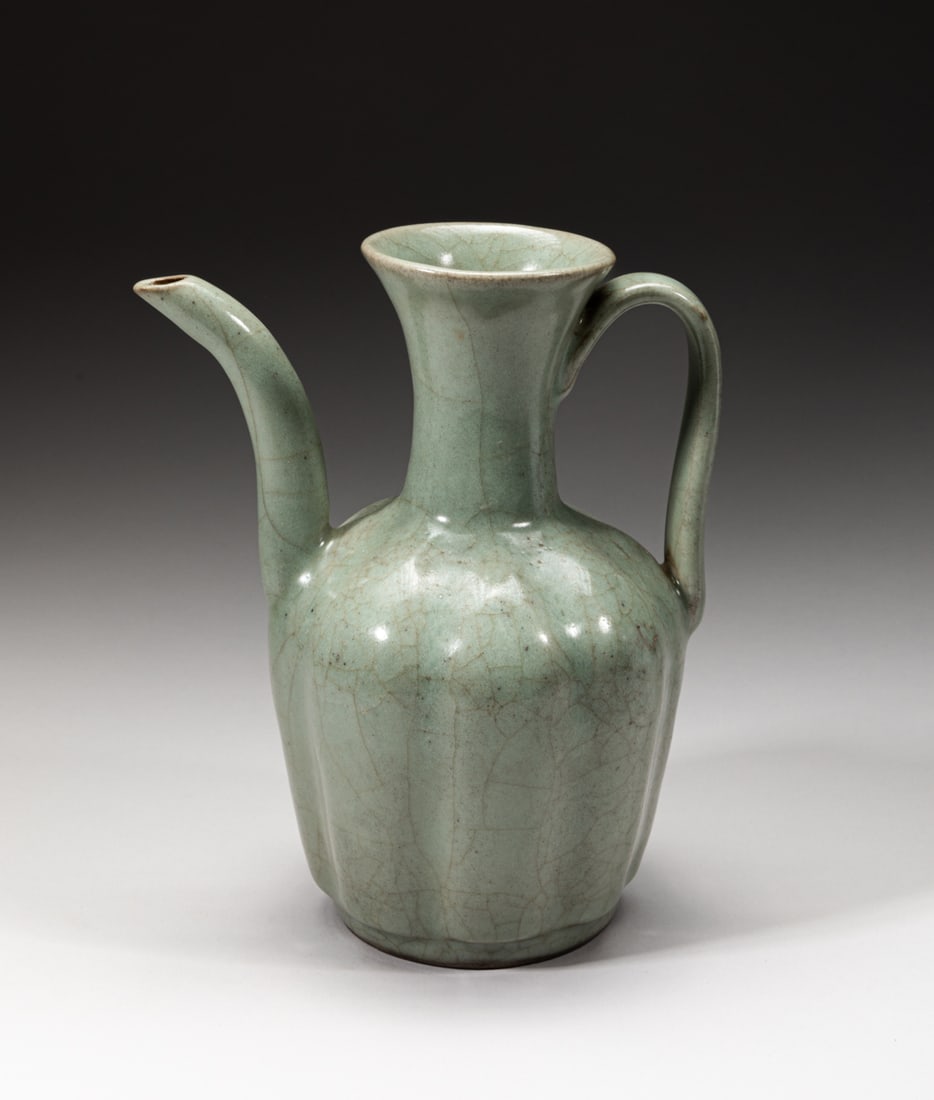 Chinese Guan Ware Porcelain Pot: One collectible Chinese Guan pot with multiple grooves on body, glazed in celadon color and suffused with crackles, one curvy handle bridged the narrow neck and its shoulder, one slender spout. Approx