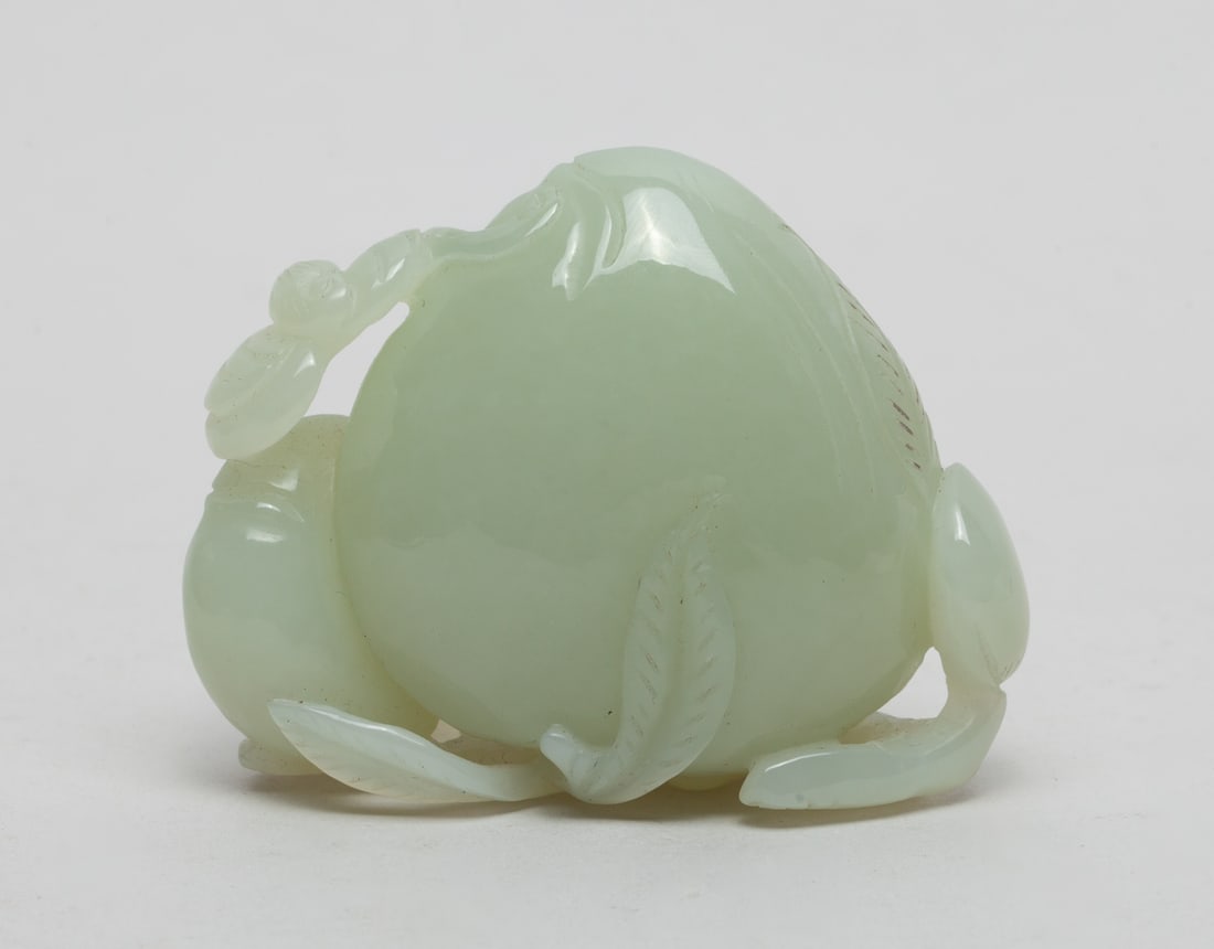 Chinese White Jade Sculpture of Peach: One collectible Chinese white jade sculpture, carved with a large peach and small one beside, with a flying bat on top. Approx. 2.5-1.1-1.9 inches.