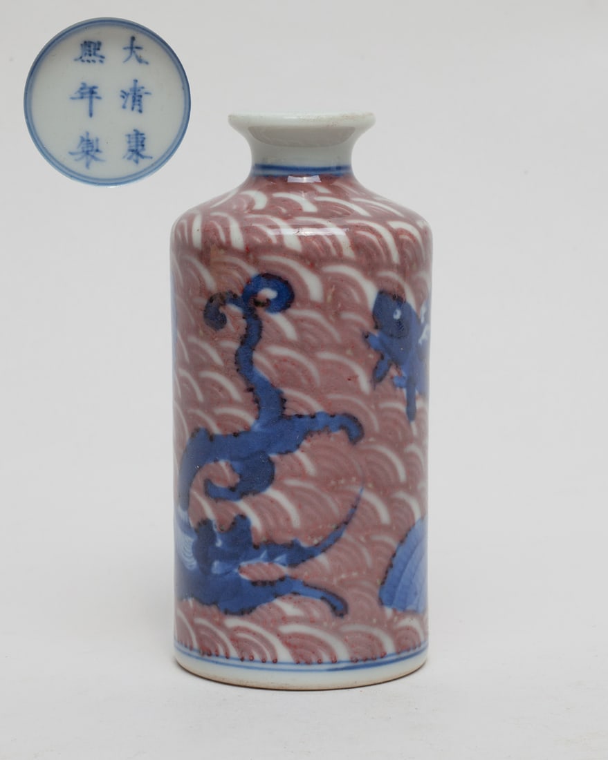 Chinese Blue White & Red Porcelain Snuff Bottle: Of cylindrical form, the collectible Chinese porcelain snuff bottle painted with a large dragon and few beast around in blue color on the wave motif ground in red color, bottom with a mark, without st
