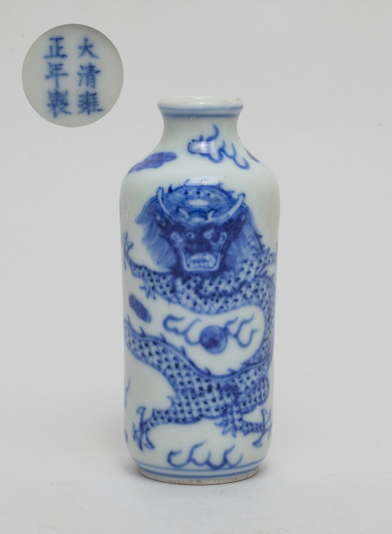 Chinese Blue & White Porcelain Snuff Bottle: One collectible Chinese porcelain snuff bottle, in cylindrical form, painted with a large sinuous dragon and fire-shape-like motifs, bottom with a mark, without stopper. Approx. 3.1-1.3 inches.