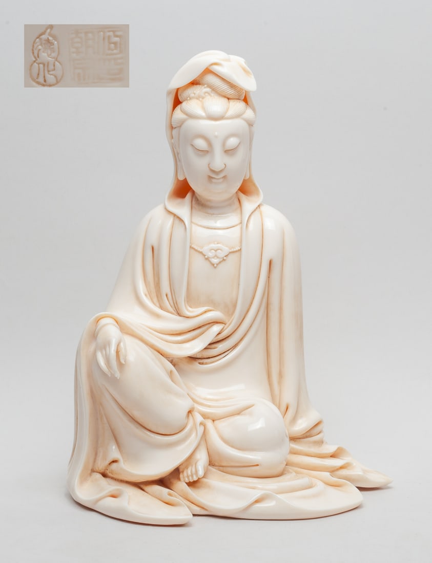 Chinese Blanc De Porcelain Kuanyin: The Buddha gracefully resting one hand on the knee of the raised leg, one arm by her side to support her weight,a necklace at the chest, with one leg crossed and the one foot partly exposed and facing