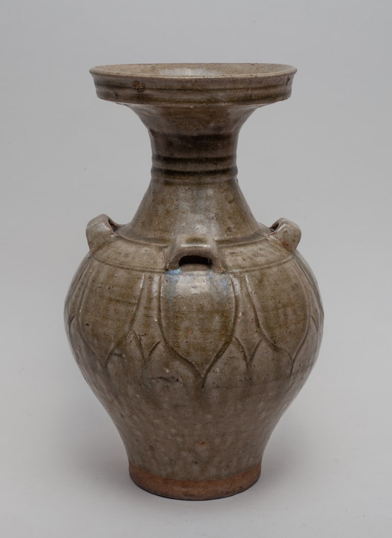 Chinese Yue Ware Porcelain Vase: Of baluster form with a large outward flaring mouth, the spherical body shoulder carved with leaf-motif and decorated with four handles. Approx. 6.6-11.0 inches.