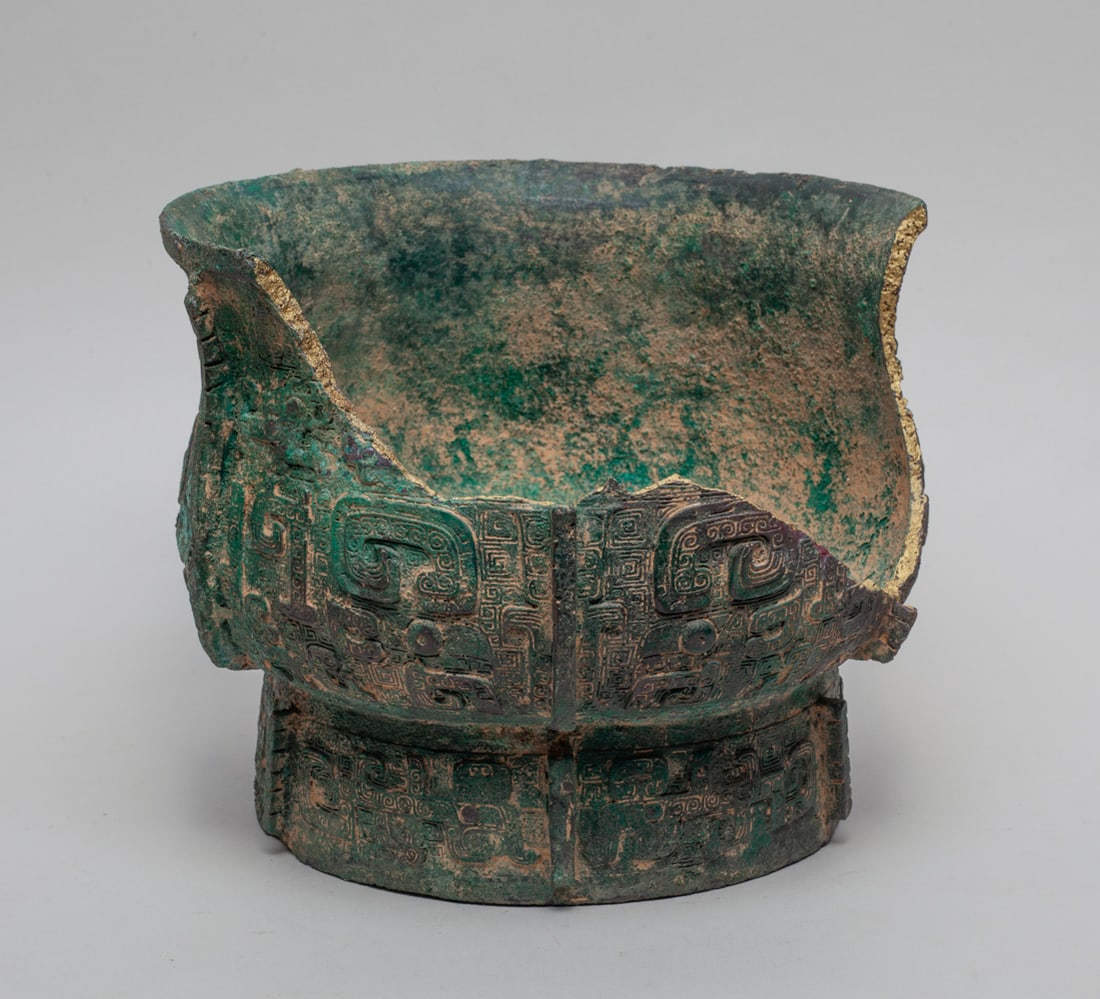 Estate Chinese Bronze Vase: Broken Chinese bronze vase, cast with archaistic beasts on leiwen ground, divided by vertical flanges. Approx. 7.3-7.3-6.0 inches.