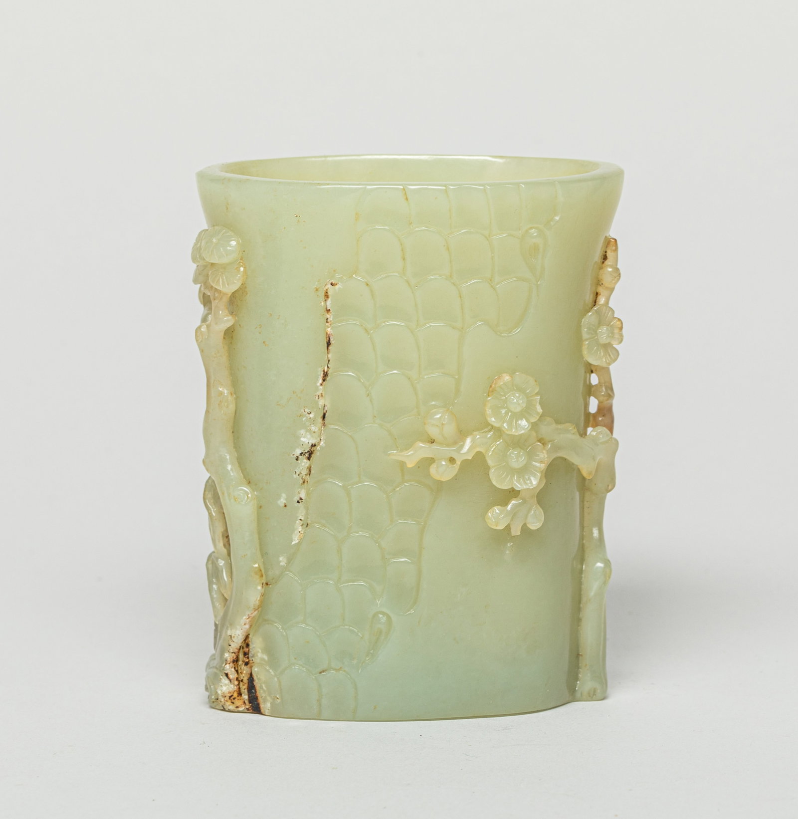Chinese Russet Jade Vase: The vase carved with a high relief of a tree, bamboo, and a flower tree. Approx. 2.5-1.4-3.1 inches.