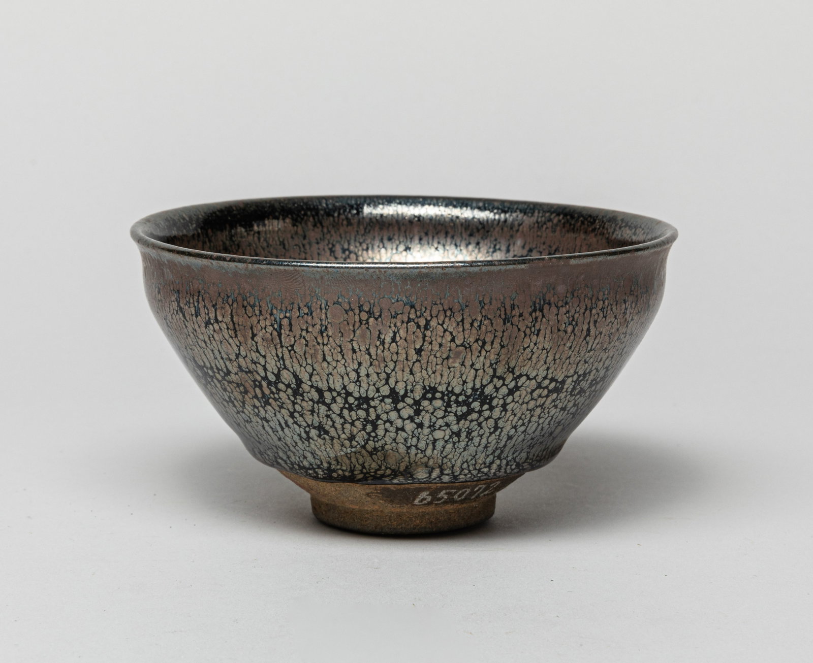 Chinese Jian Ware Porcelain Tea Bowl: Chinese Jian tea bowl, applied in black color glaze with lustrous russet streaks, the bottom carved with characters. Approx. 5.0-2.6 inches.