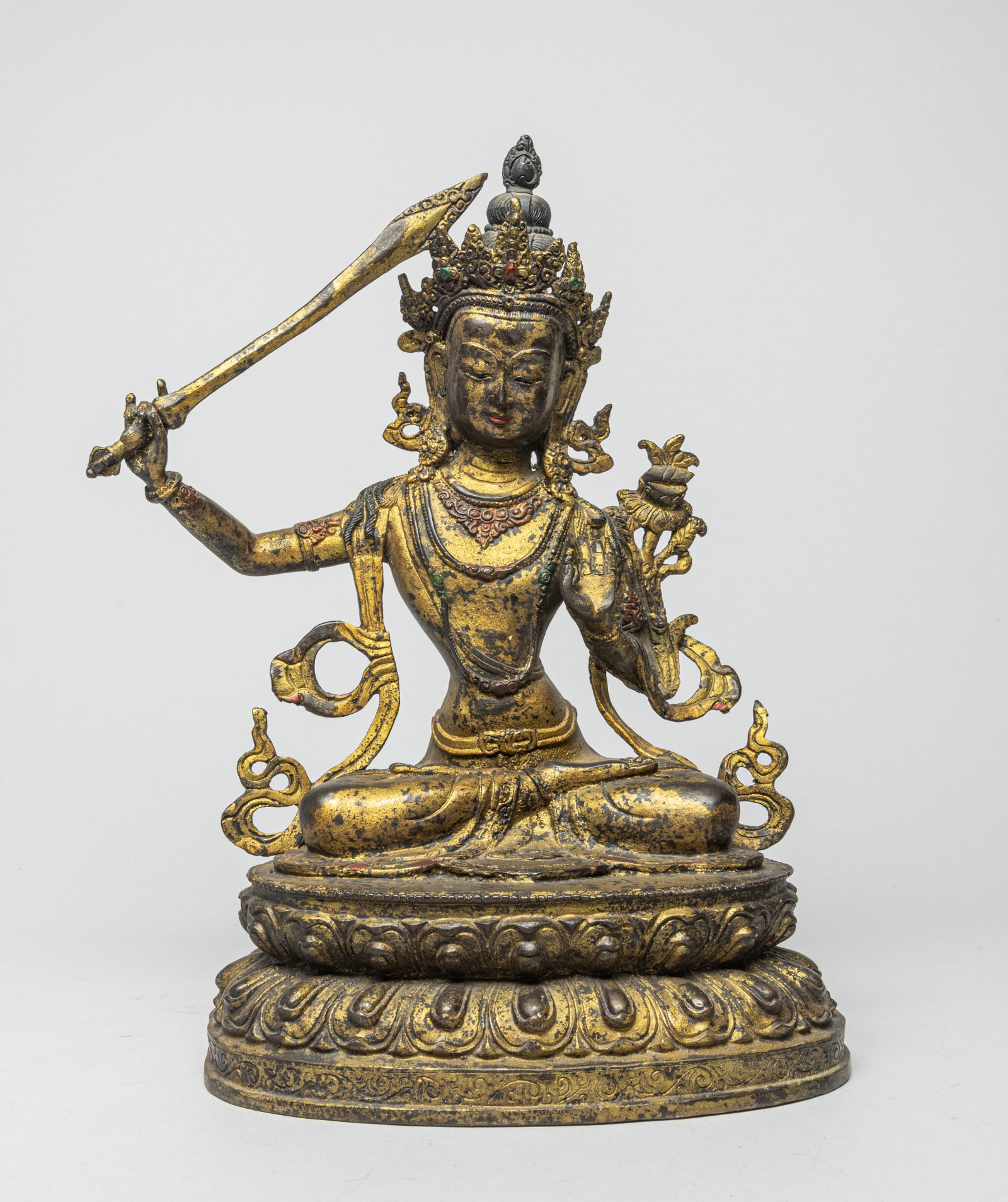 Chinese Gilt Bronze Buddha: The seated Buddha in Dhyana pose on a double-layer lotus platform, with one hand holding a sword and the other one forming a Gyan Mudra. The bottom bearing a mark. Approx. 8.0-6.0-13.0 inches.