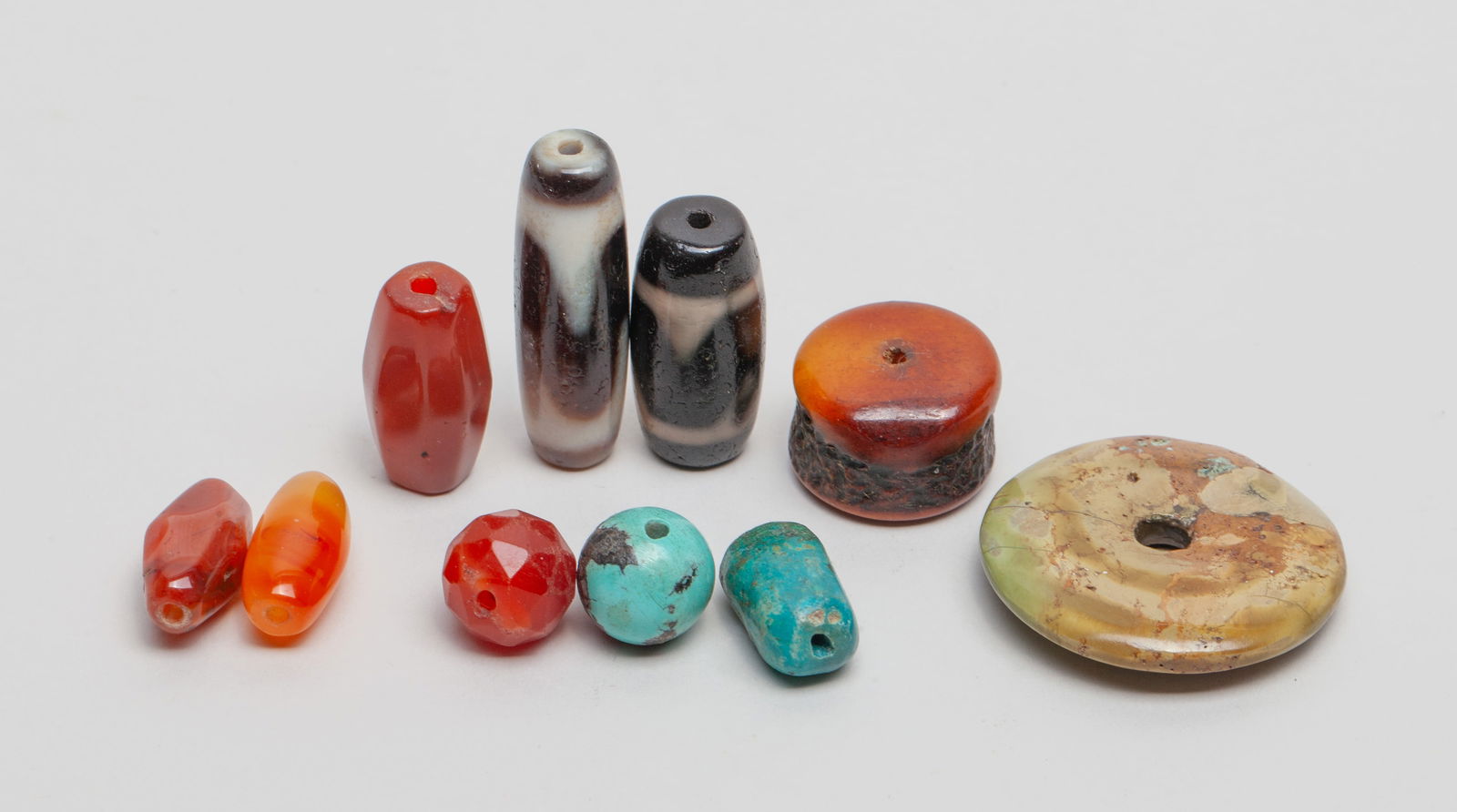 Chinese/ Tibetan Dzi, Agate Bone Beads: A group of Chinese/ Tibetan Dzi and agate bone beads. Approx. 1.5 inches (Longest). The Estate of DT Los Angeles Store Closed Sale.