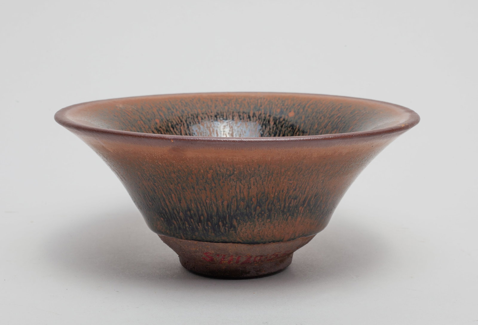 Chinese Jian Ware Porcelain Tea Bowl: Covered in black color with brown streaks. Approx.5.1-2.1 inches.