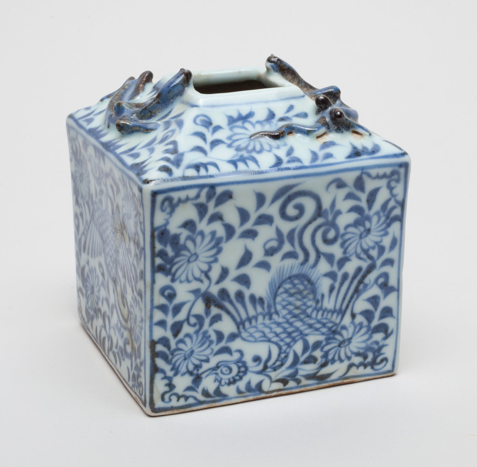Chinese Porcelain Water Pot: Of cubical form, the pot exterior painted with pairs of birds amidst a floral motif on each side, and two beasts in high relief at the rim. Approx. 3.2-3.2-3.5 inches.