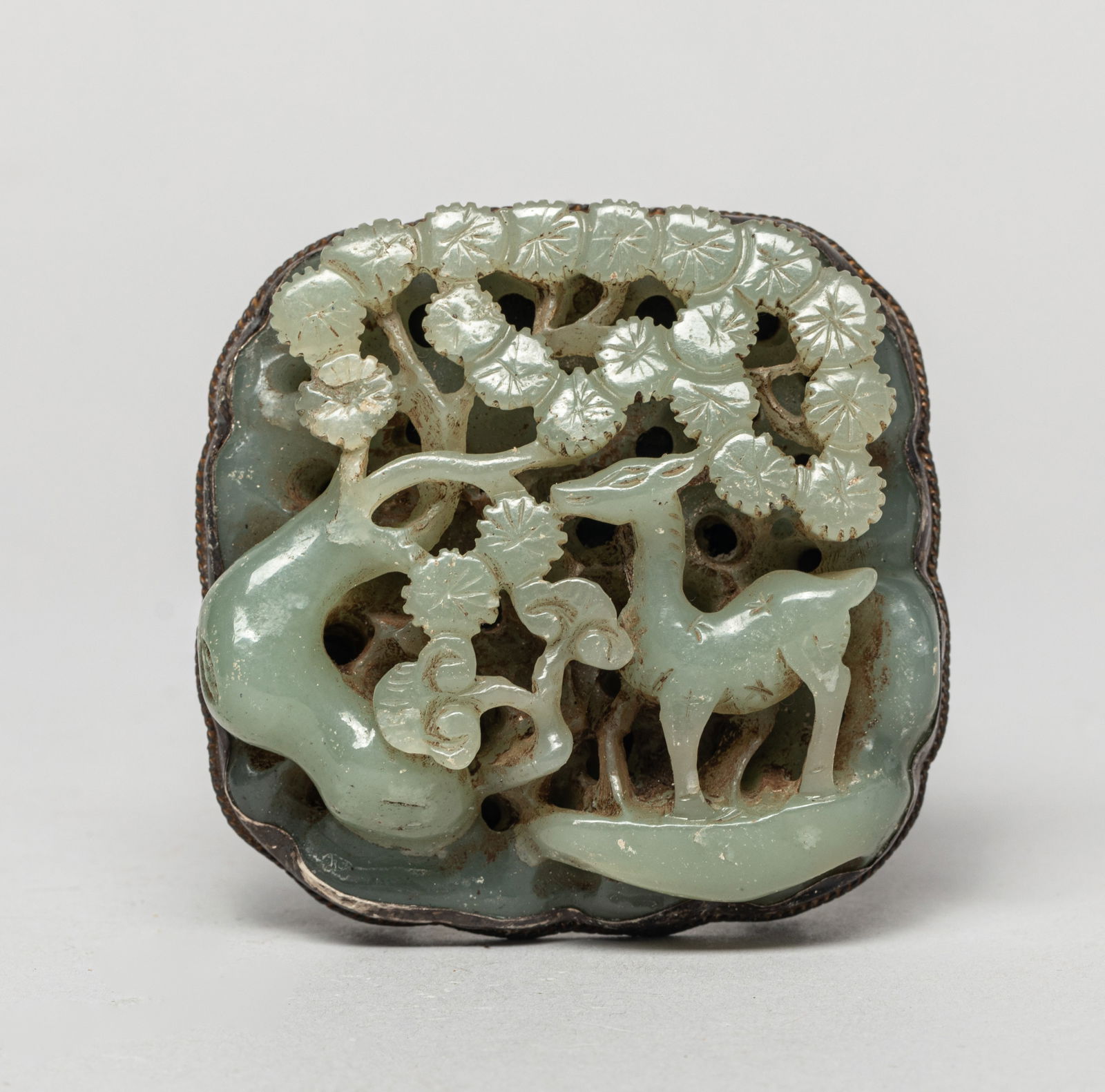 Chinese Jade Carved Belt Buckle: Carved in openwork with a deer standing around a pine tree and lingzhi. Approx. 2.39*2.35 inches