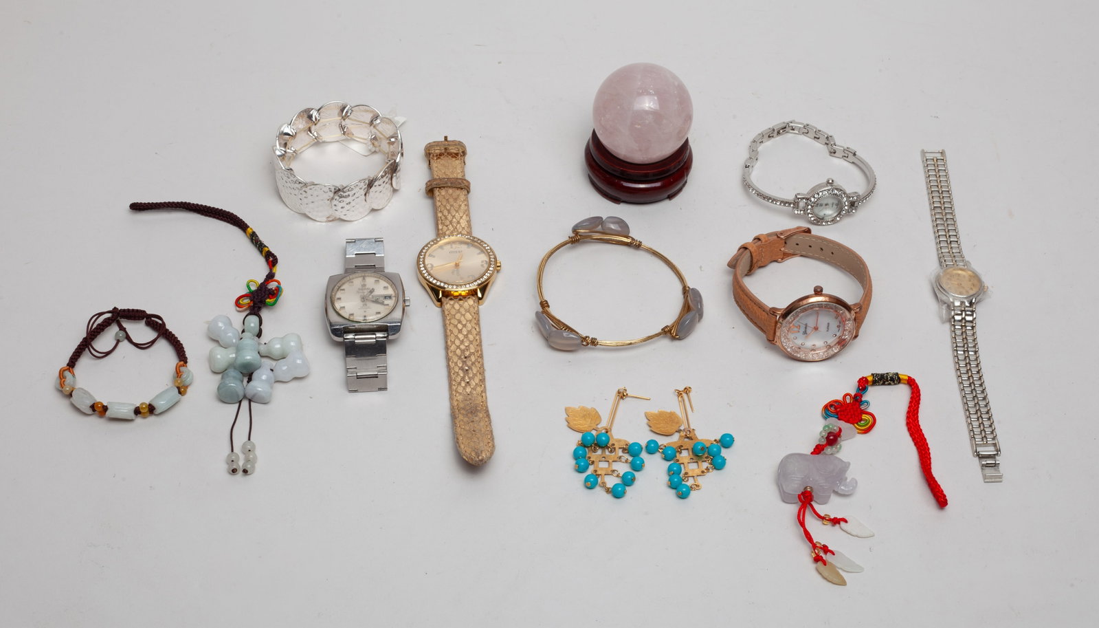 Estate Rose Quartz & Jewelry: Including a quartz ball with a stand, bracelets, earrings, pendants, and four watches with unknown conditions. Size varies.