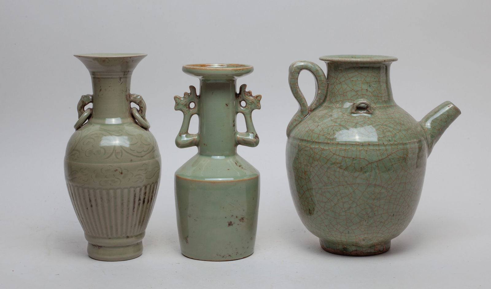 Estate Chinese Porcelain Vases: Group of three Chinese porcelain vases applied in mottled celadon glaze, the largest vase surface suffused with brown crackles. Approx. 9*8*6.5 inch (largest).