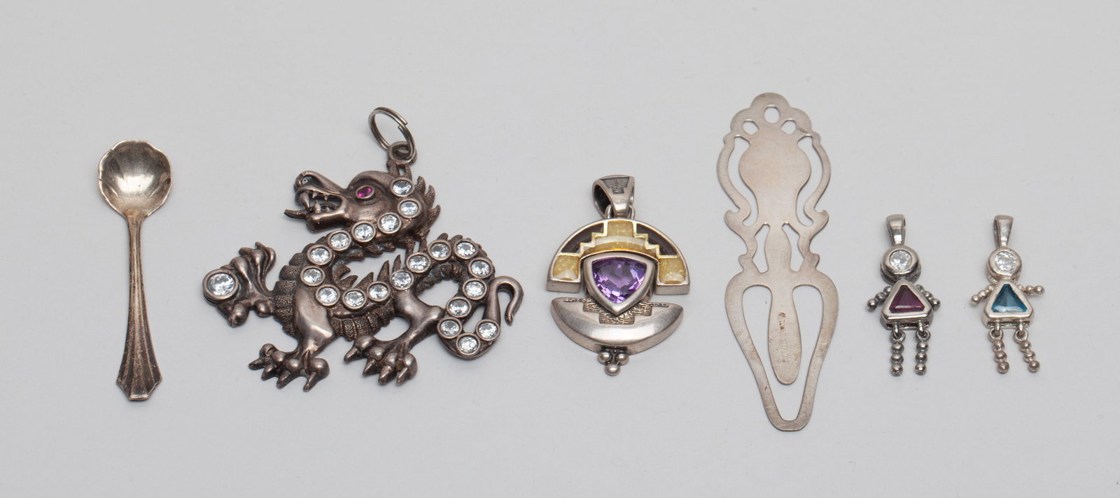 Collectible Sterling Silver w/ Gemstone: Including a mini spoon, three pendants, a dragon form pendant and a bookmark, the pieces marked STERLING or 925. Approx. 35 gram (total weight).