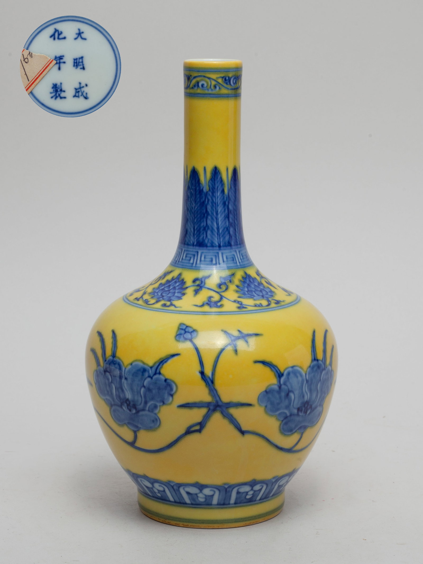 Chinese Export Porcelain Vase: The vase body painted with undulating flower sprays, beneath bands of upright leaves and lotus scrolls, against a bright yellow ground, the bottom marked with six characters enclosed in double circles