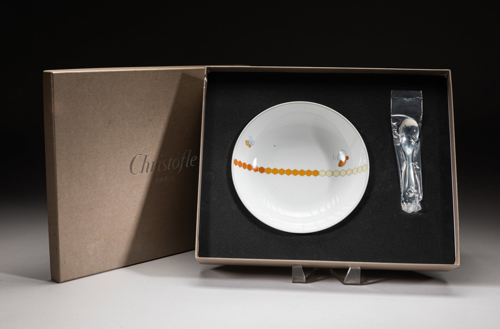 Collectible Christofle Paris Service: Including a glazed plate, interior painted with two flying bees and a line of honeycomb, exterior bottom marked with CHRISTOFLE MADE IN FRANCE , and one silver-like spoon. Approx. 7.4-1.6 inches (Larg