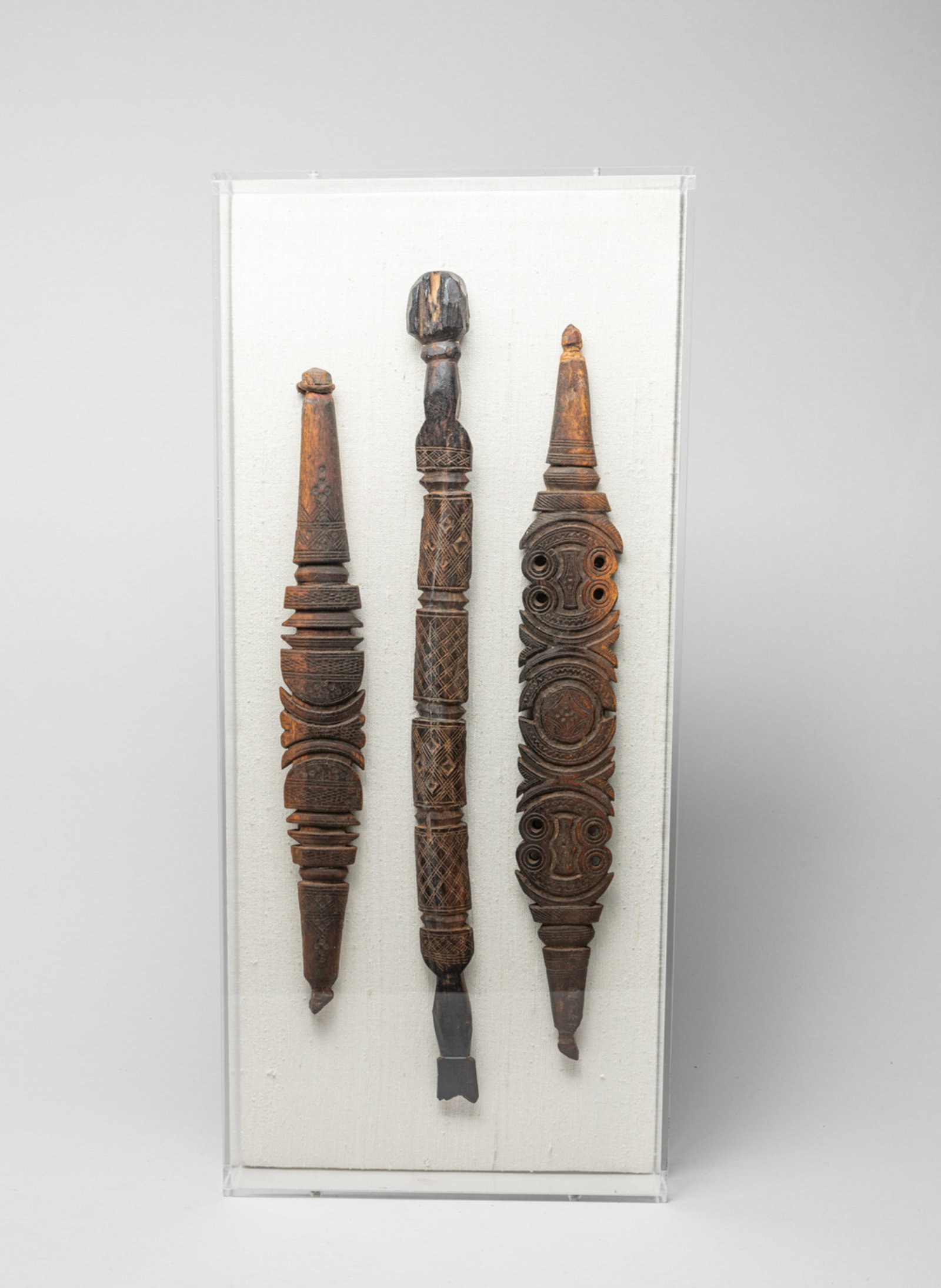 Hand Carved Wood Artifacts: Set of three special hand carved wood artifacts, with acrylic frame. Approx. 22*10 inch (frame size).