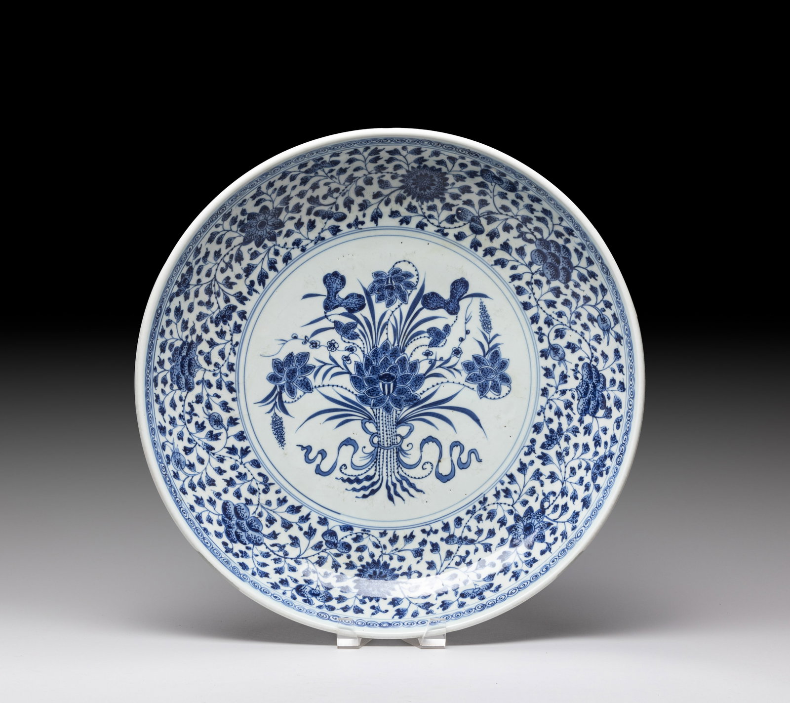 Large Chinese Porcelain Charger: The interior center painted with beribboned lotus, surrounded with a band of meandering lotus sprays, the exterior with similar lotus sprays. Approx. 16.6*3.2 inch.