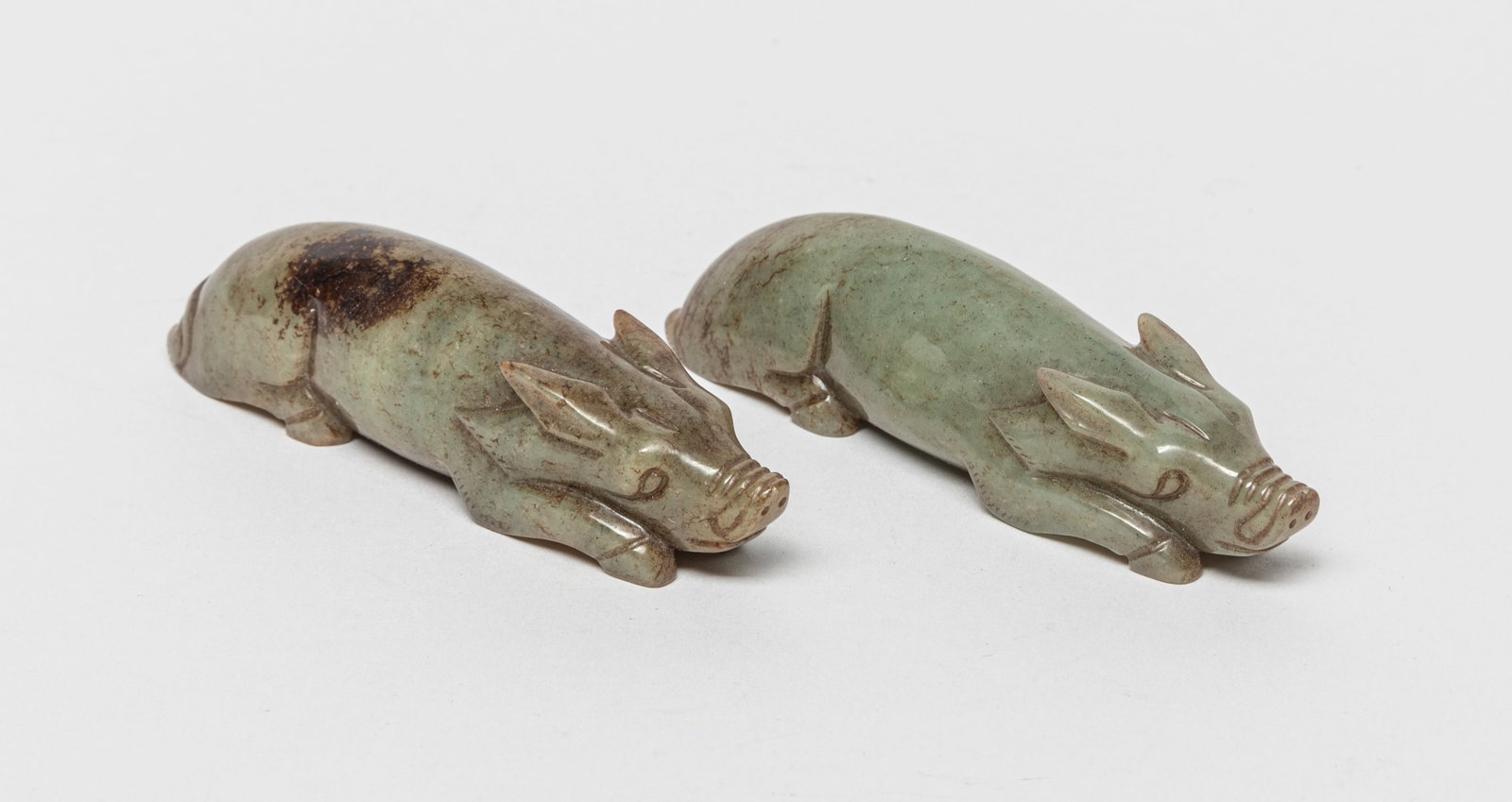 Two Chinese Jade Carvings of Pig: Two russet jade carvings, carved in recumbent pig form. Approx. 3.8*1*0.9 inch (each).