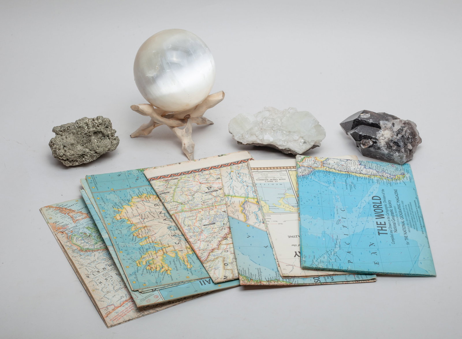 Maps, Crystal Ball & Gemstones: Including maps, a crystal ball with stand, and three gemstone table sculptures. Approx. 4.25inch D (crystal ball size).