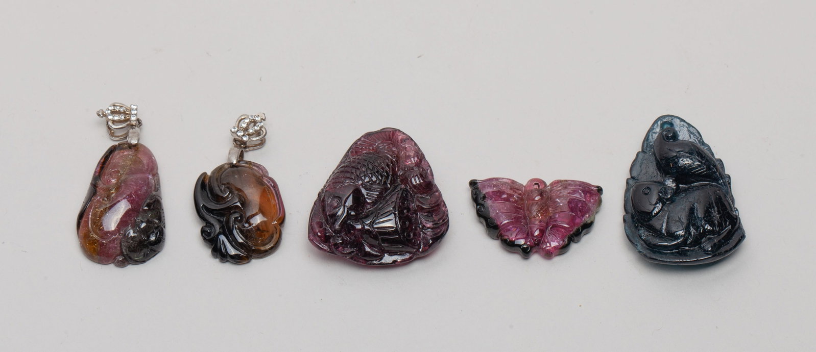 Chinese Tourmaline Carved Pendants: Five tourmaline pendants, carved in form of butterfly, lingzhi, lingzhi and bat, squirrel and leaf, or fish, lotus and leaf. Approx. 1.06*1.02 inch (larger); 27 gram (total weight).