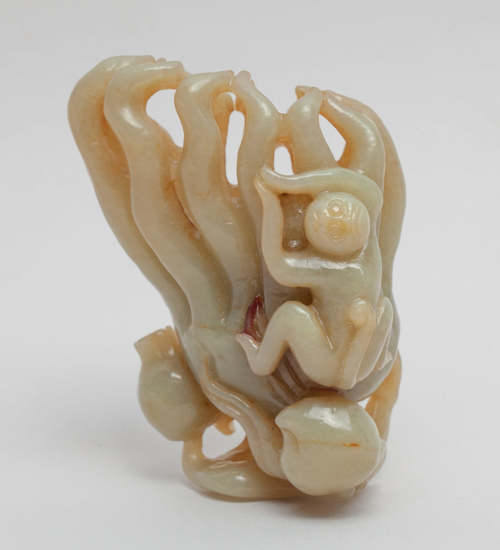 Large Chinese Jade Carved Buddha Hand: Naturalistically carved as a large buddha hand citrus, a smaller peach and a pomegranate issuing from a gnarled stem, a monkey clambering along the citrus. Approx. 3.1*2.2*1.5 inch.