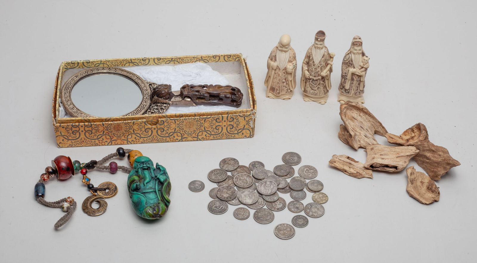 Chinese Mirror, Agarwood Bark & Decors: Including 3 sculptures carved in Sanxing Fu Lu & Shou form, agarwood bark pieces, Chinese Fengshui coins, a decor with beads and a Shoulao form toggle, a Chinese hand mirror cast with a pair of dragon