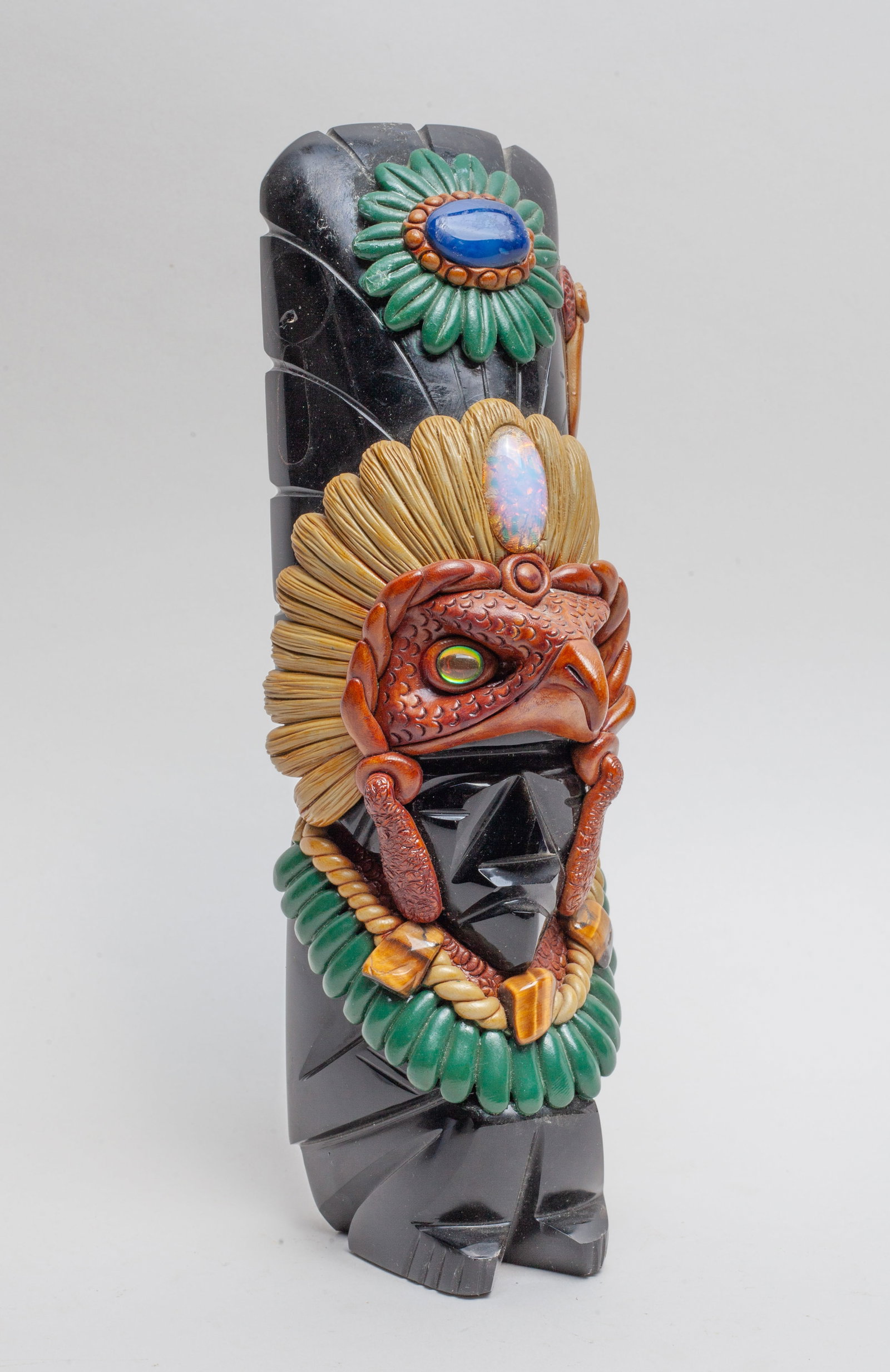 Mexican Jet Stone & Lapis Sculpture: Mexican type jet stone, lapis, and gemstone sculpture carved in tribe chief form. Approx. 9.6*3.15*3.05 inch.