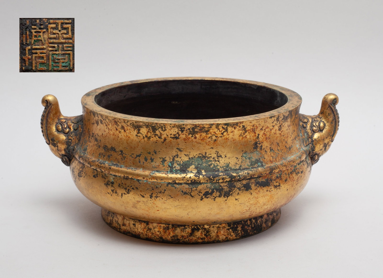 Chinese Gilt Bronze Censer: Of compressed form with a pair of beast mask handles, set with a raised border on the body, the bottom incised with a four-character mark. Approx. 9*7.2*3.6 inch.
