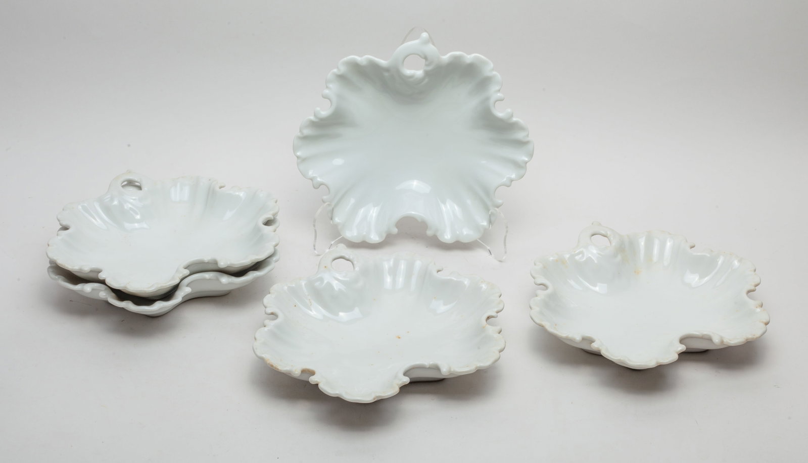 Chinese Export Cream Glazed Porcelain Plates: Set of 5 Chinese creamy-white glaze porcelain plates, each of flower form with a pierced handle. Approx. 8.5*8 inch (each).