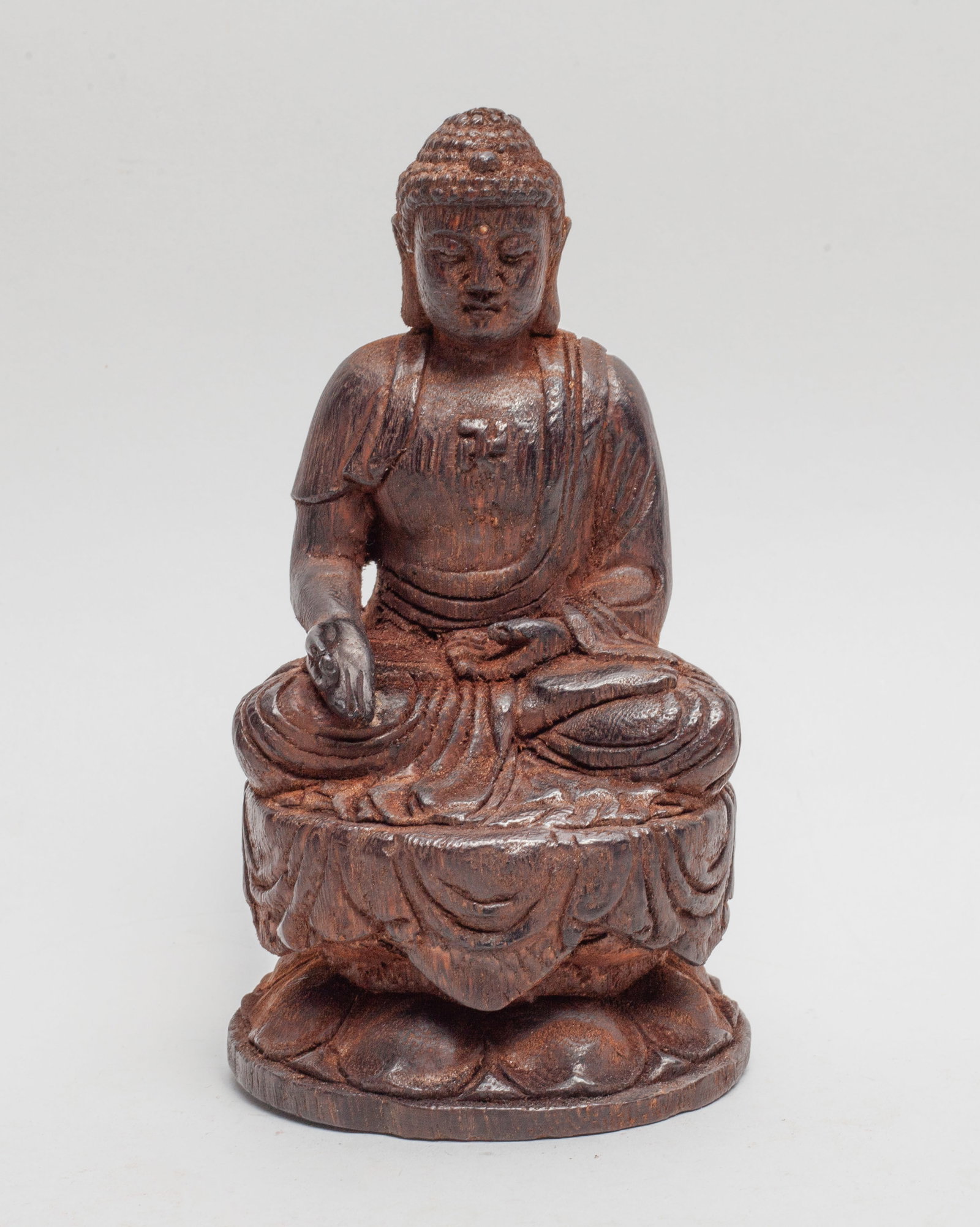 Chinese Bark of Agarwood Sculpture of Buddha: Chinese bark of agarwood Buddha sculpture, carved seated on a double lotus base, the left hand in varada mudra and the right hand in gyan mudra, wearing a loose-fitting robe open at the chest carved w