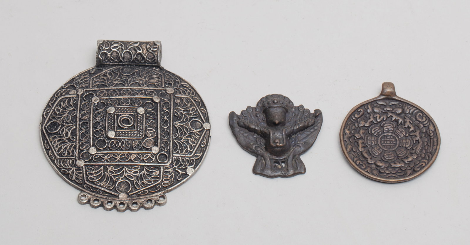 Collectible Chinese/ Tibetan Metal Pendants: Group of three Chinese/Tibetan metal pendants. Approx. 3.18*3.64 inch (largest)
