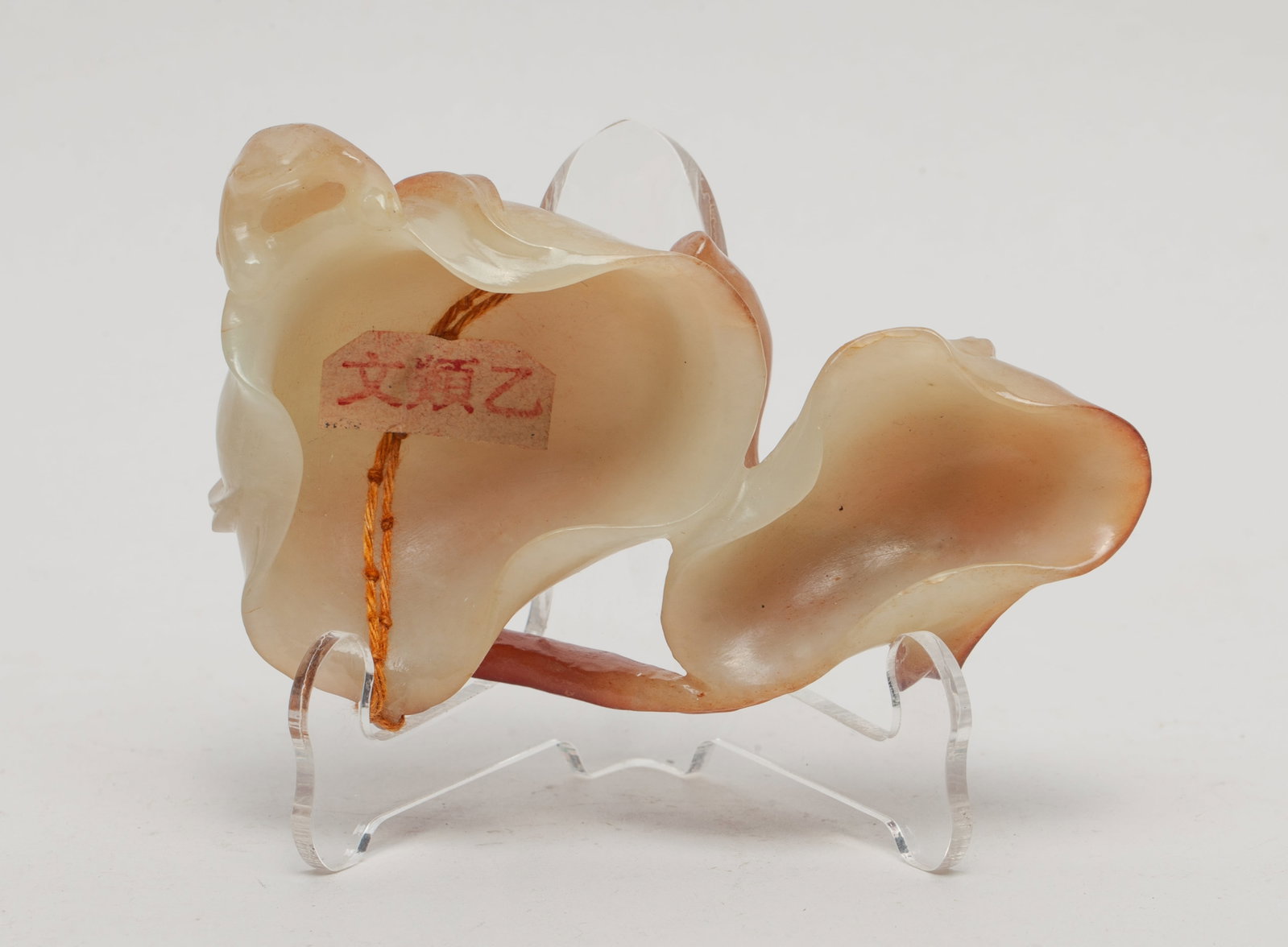 Chinese Russet Jade Lotus Form Washer: Naturalistically carved in high relief as two hollowed lotus leaf, supported on a long gnarled branch which curls up and around the bottom of the vessel, a frog clambering on the side. Approx. 4*2.6*1