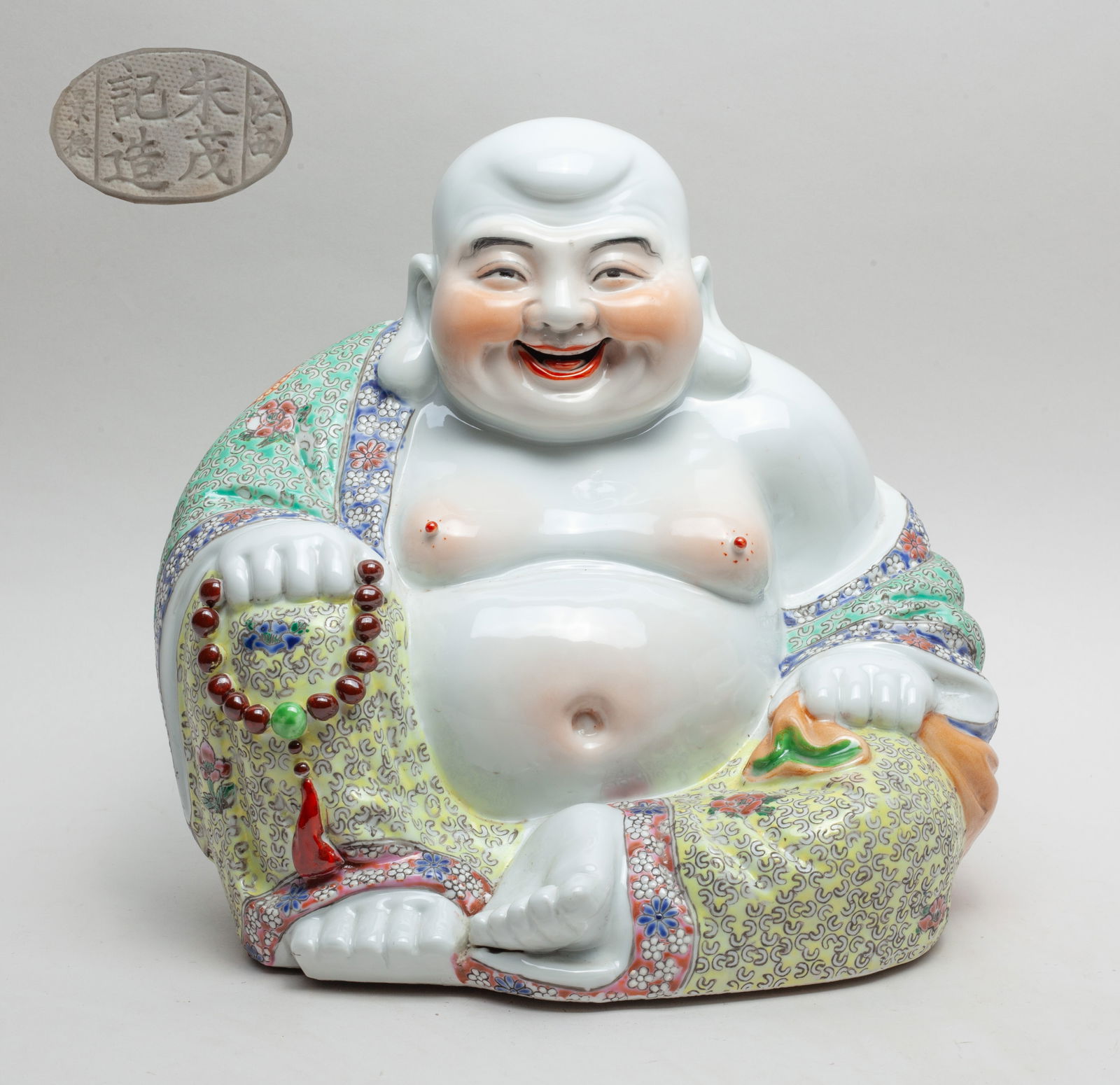 Large Chinese Porcelain Buddha: Laughing Buddha dressed in a loose robe enameled with flowers and shou character on turquoise and yellow ground. Approx. 10.3*10.3 inch