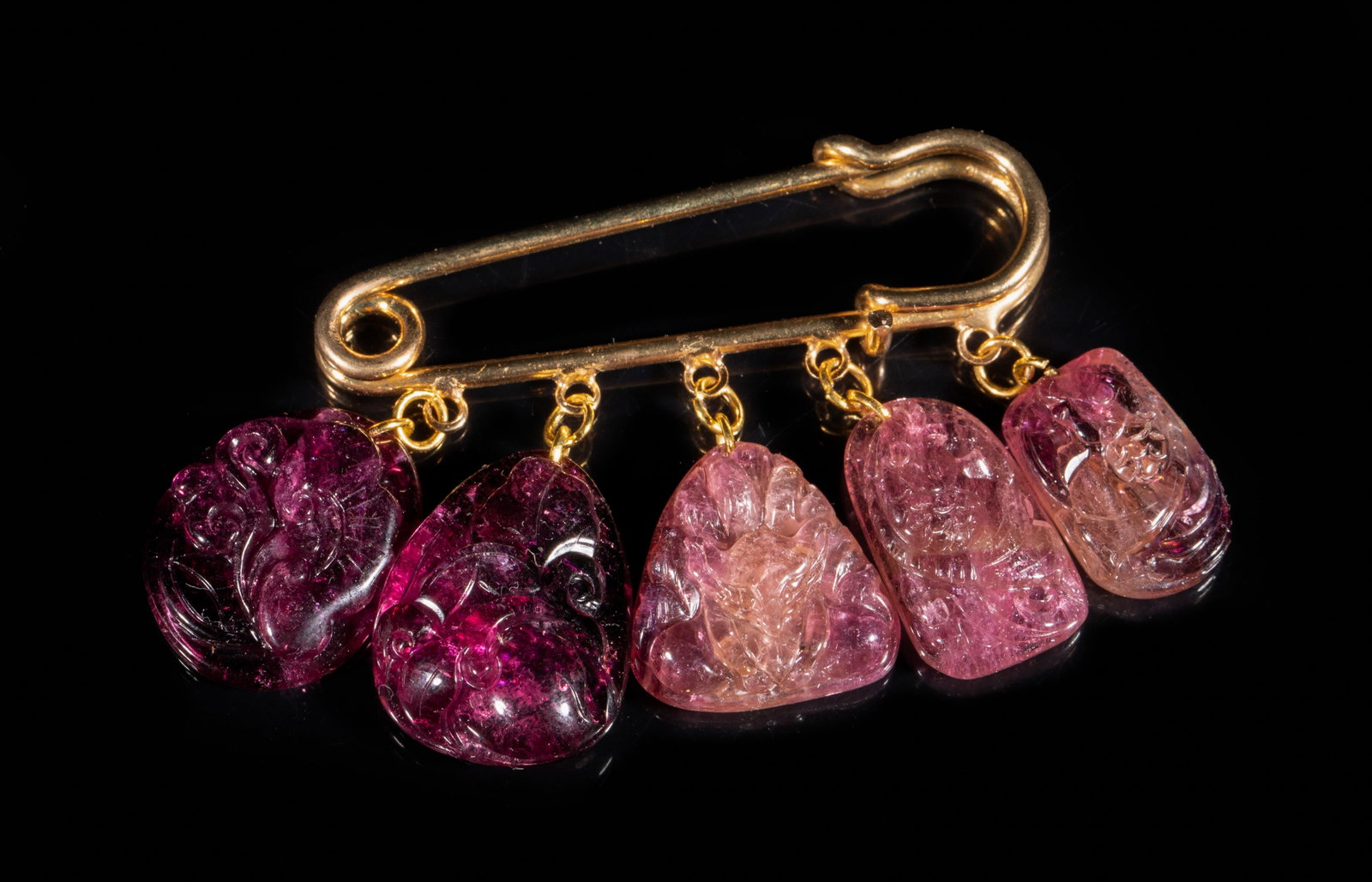Chinese Tourmaline Brooch Pendant: Chinese pin form brooch, suspended with five tourmaline pendants, carved with carp, squirrel, lingzhi, peach, and coin. Approx. 0.85*0.7 inch (largest pendant).