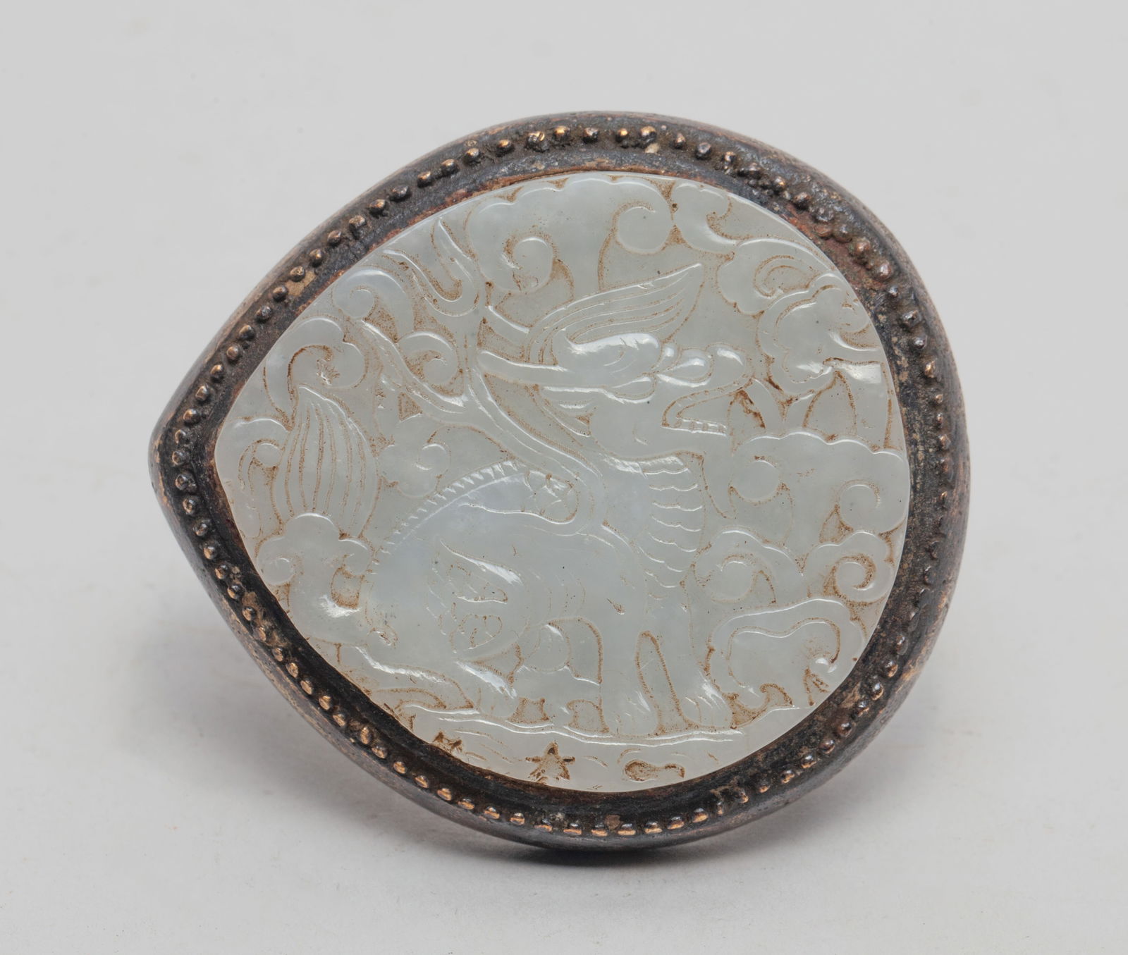Chinese Brass Inlaid Jade Belt Buckle: Chinese brass belt buckle inlaid with white jade, carved with qilin and lingzhi, the underside cast in openwork with foliage scrolls. Approx. 2.38*2.14 inch.