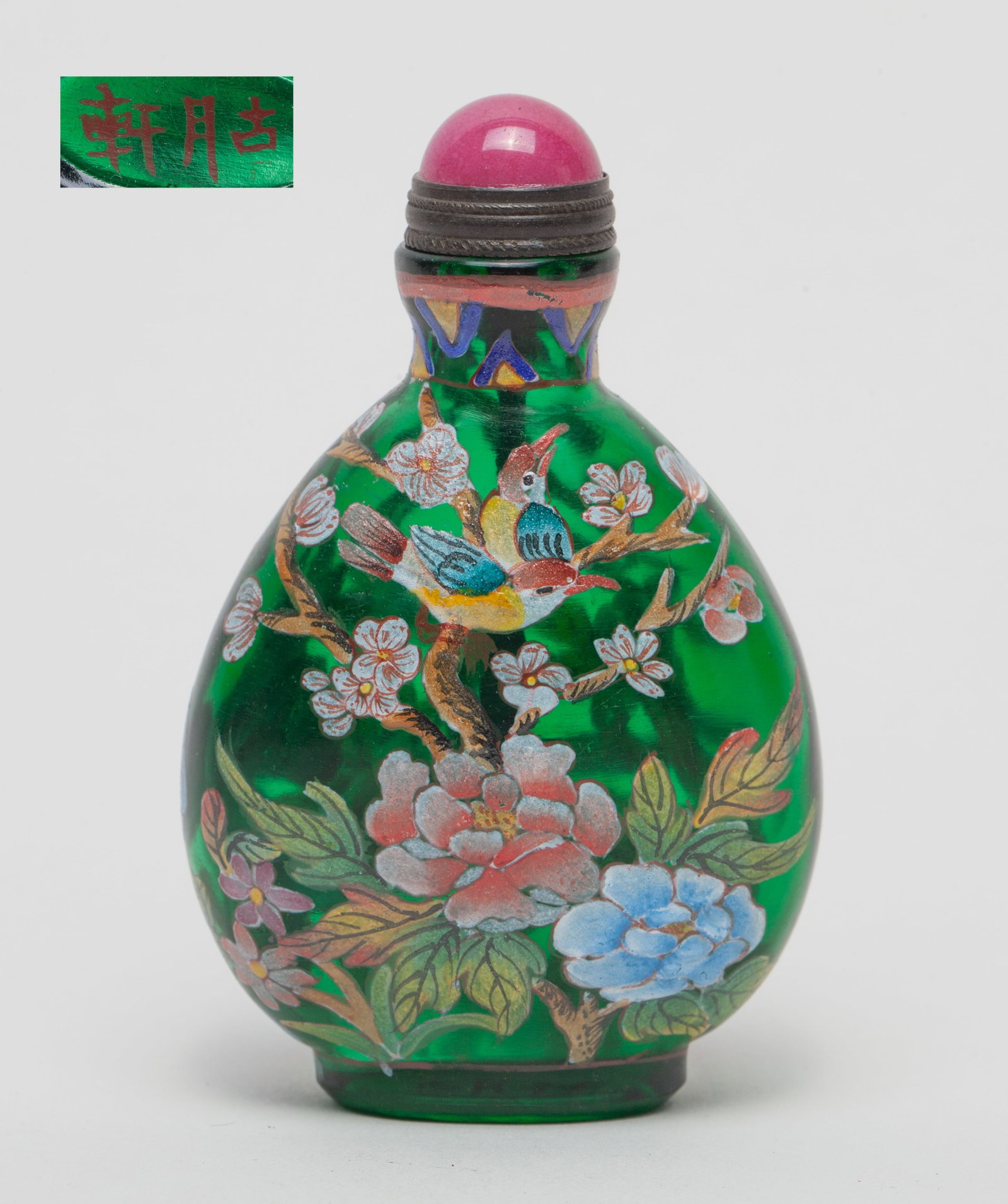 Chinese Enameled Peiking Glass Snuff Bottle: Of flat ovoid form, painted with birds, blossoming flower tree and rockery on translucent green glass, the bottom marked with two characters, with stopper. Approx. 3*1.9*1.1 inch (w/ stopper).