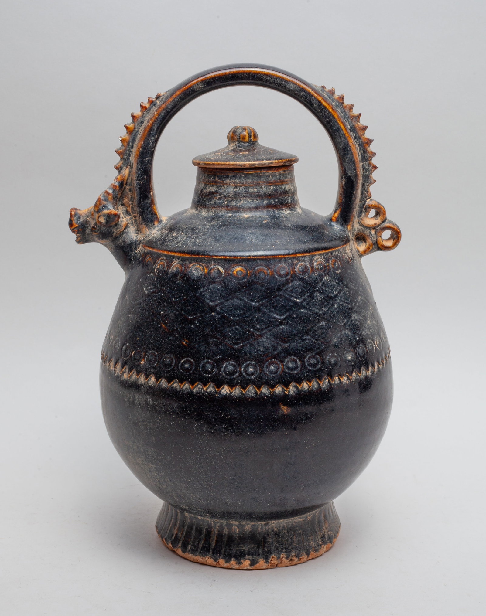 Chinese Sanchai Stoneware Pot: Of ovoid form incised with a band of traditional motif, the handle moulded in stylized beast form, the exterior covered in crackled black glaze, the bottom unglazed. Approx. 11.3*7.2*6.6 inch.
